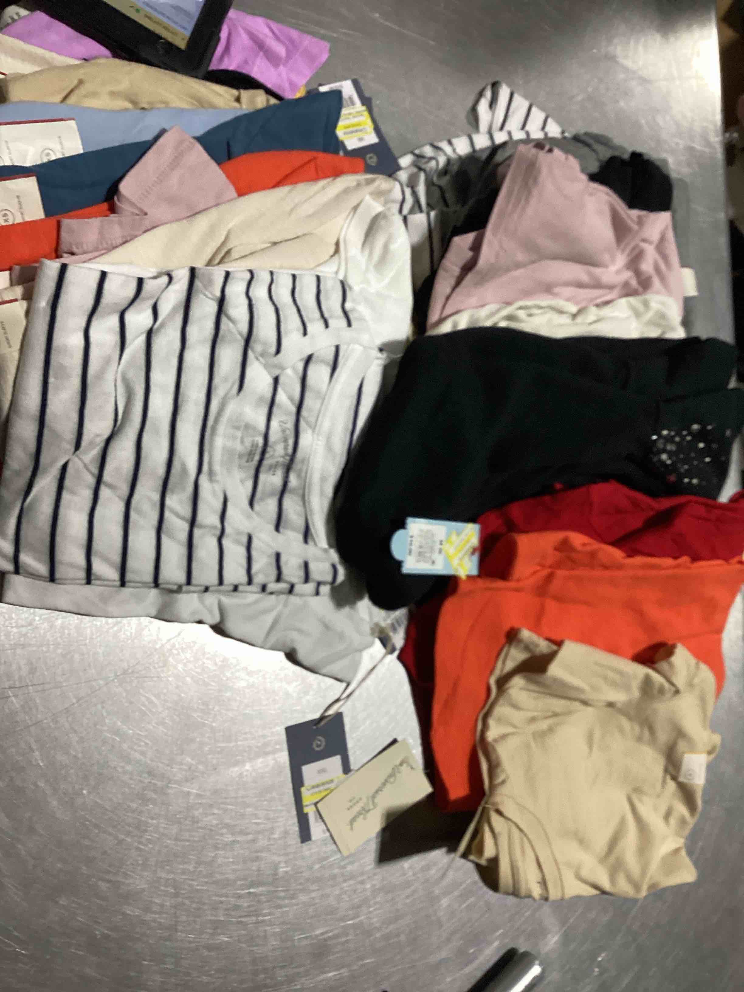 Assorted lot of various clothing such as shorts,pants,skirts and shirts,tank tops and so much…