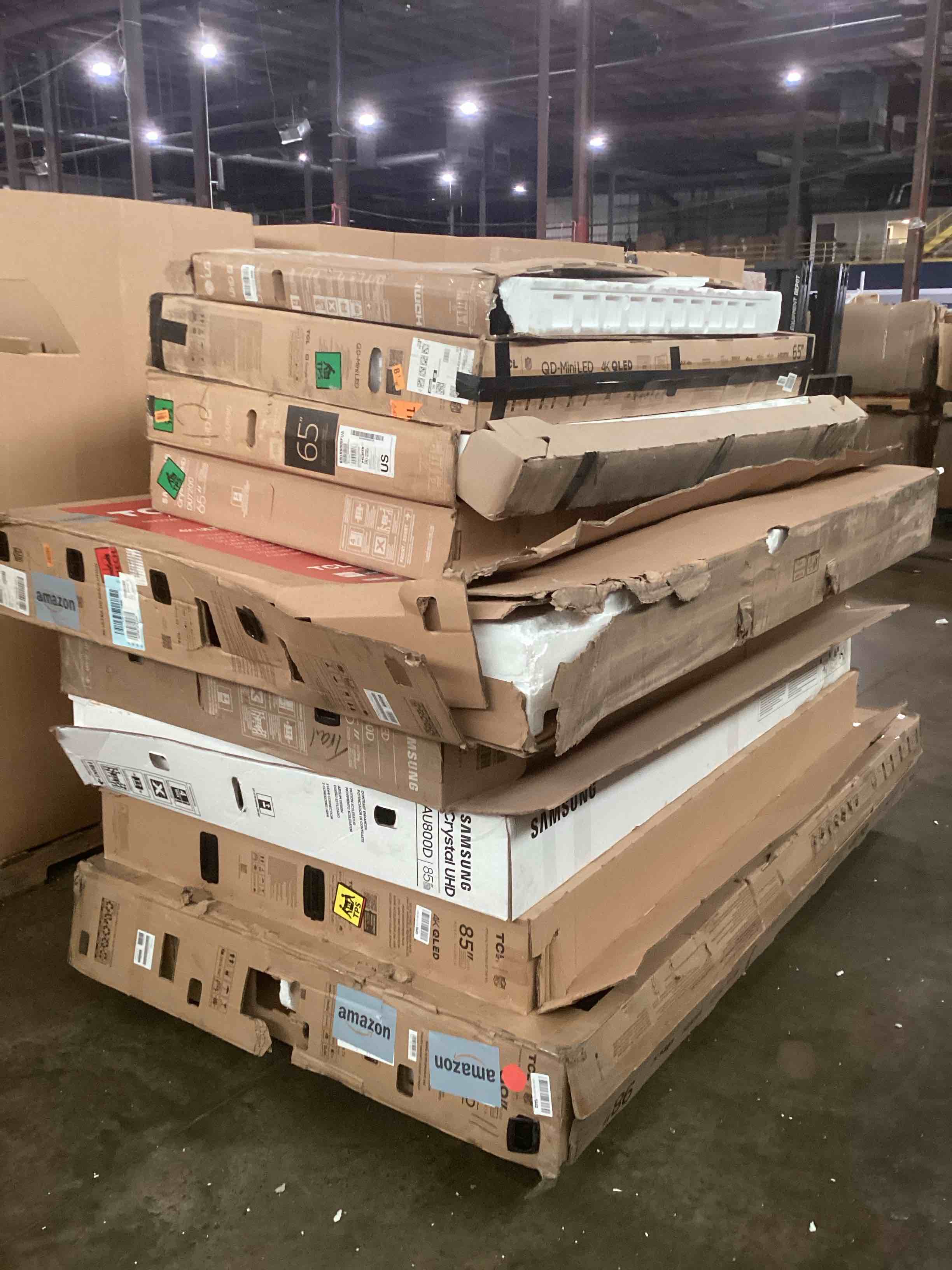Pallet of broken tvs. Various sizes and brands.