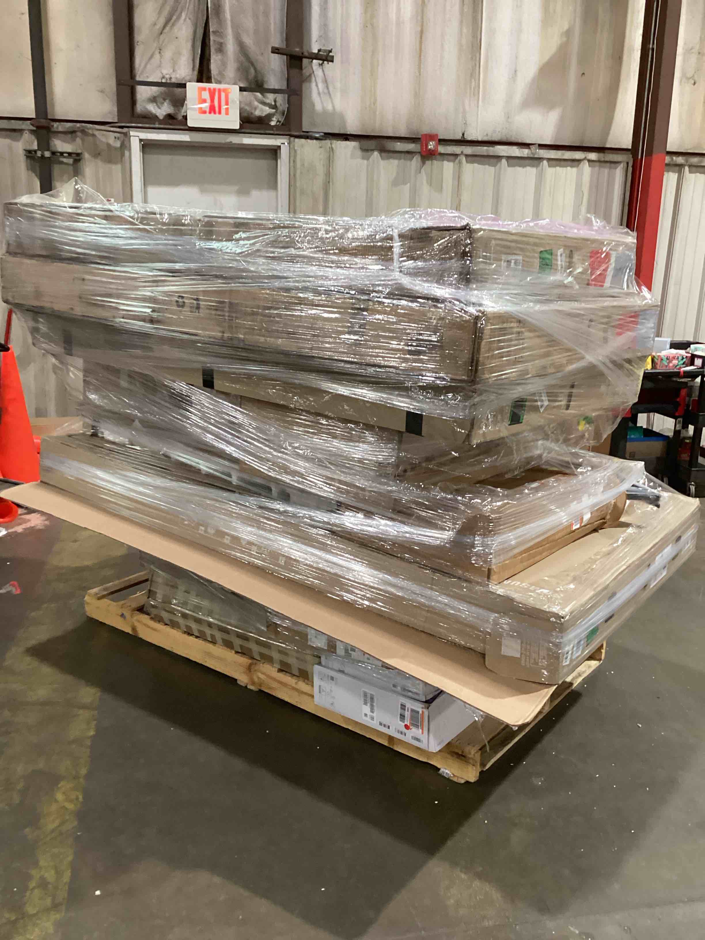 pallet of broken tvs,monitors and laptops