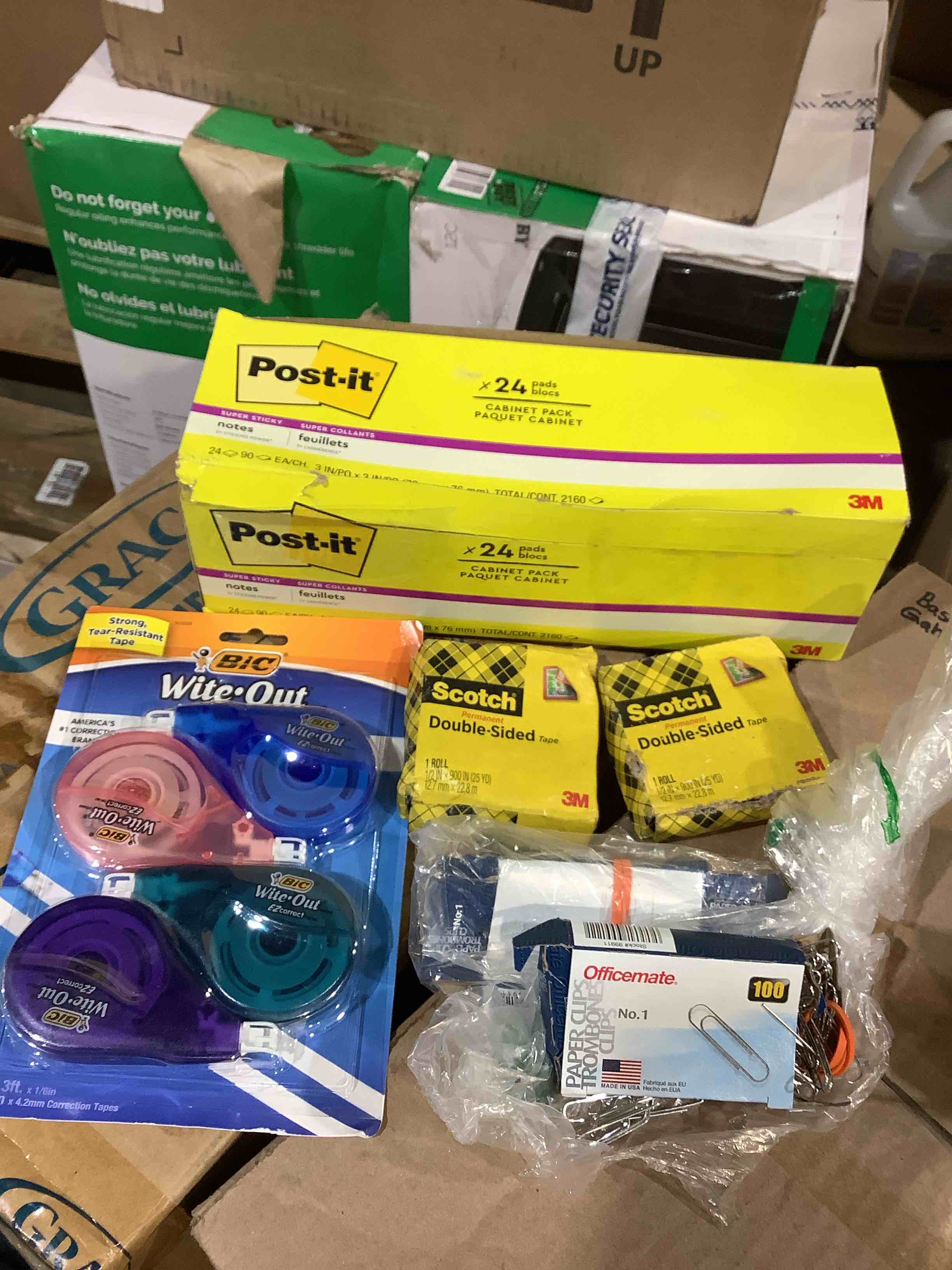 assorted office supplies: post-it notes, bic white out, scotch, double-sided tape, office mat paper clips