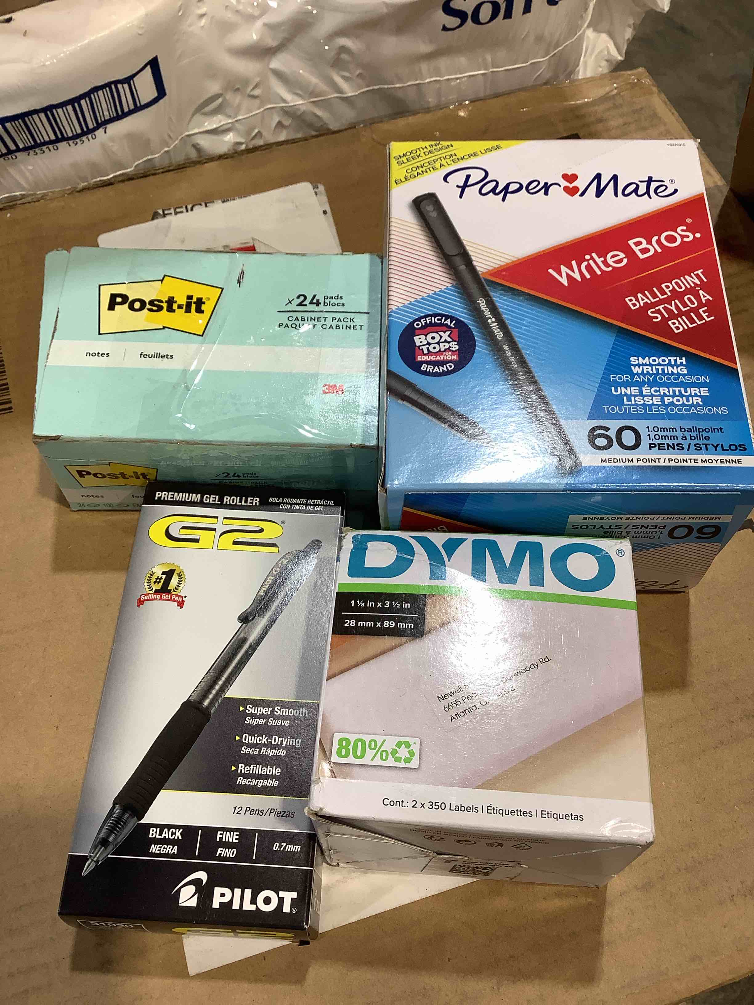Condition photo showing Good Condition for assortment of office supplies: dymo labels, papermate pens, post it notes, pilot g2 pen