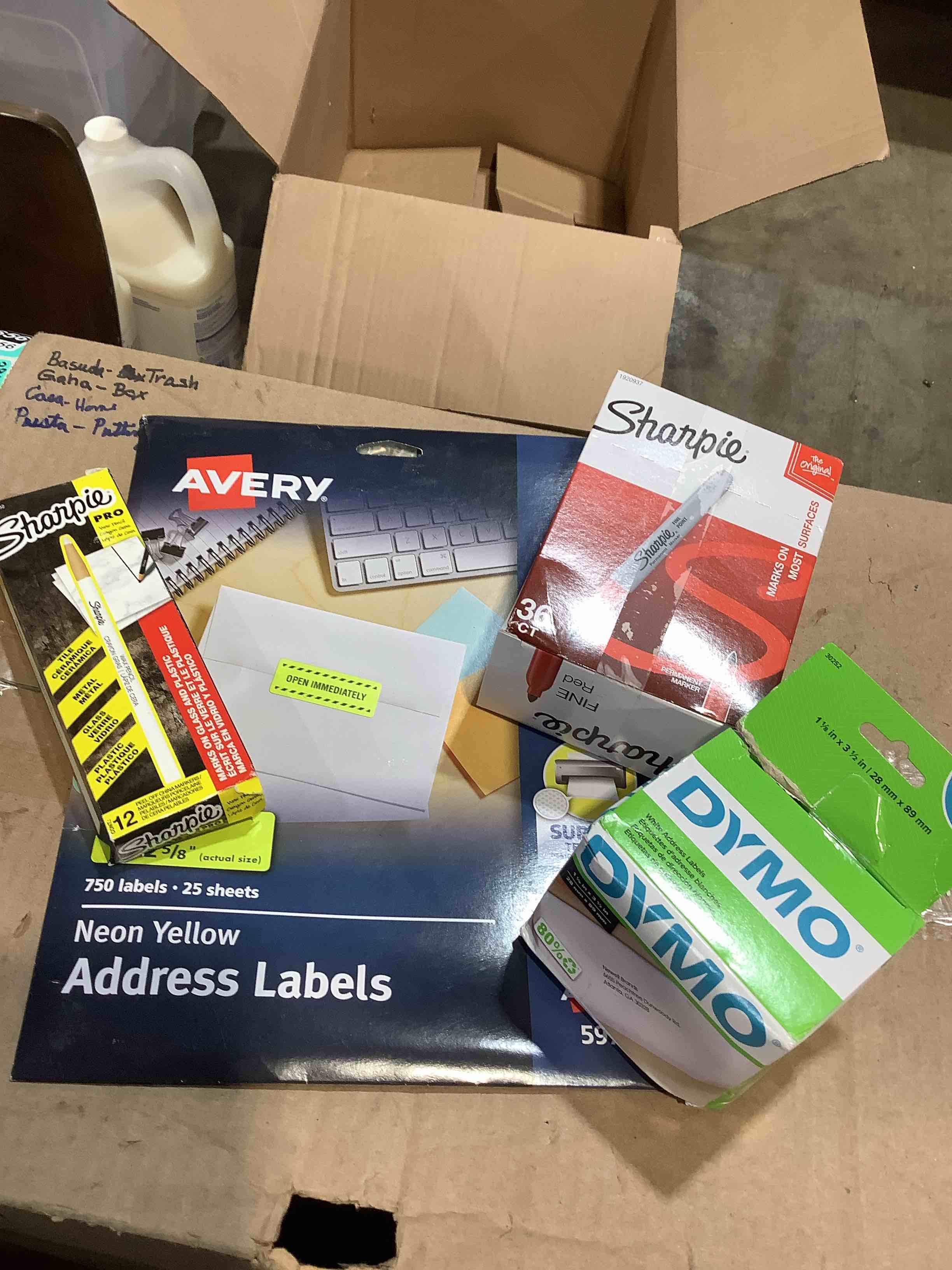 Assorted office supplies: dymo labels, Red sharpies, Avery address labels, Sharpie glass markers 