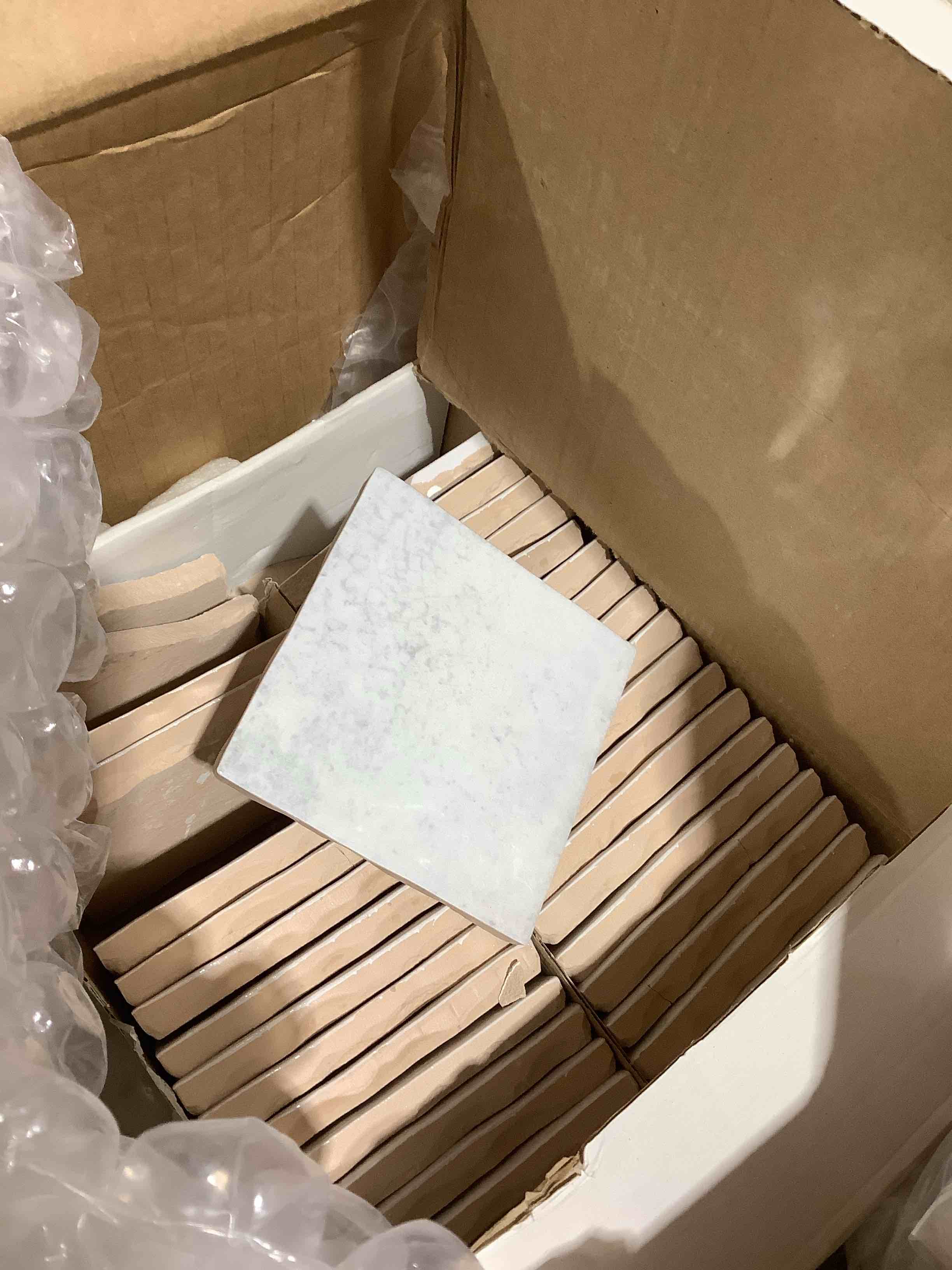 Condition photo showing Good Condition for box of 4" x 4" white marble tile