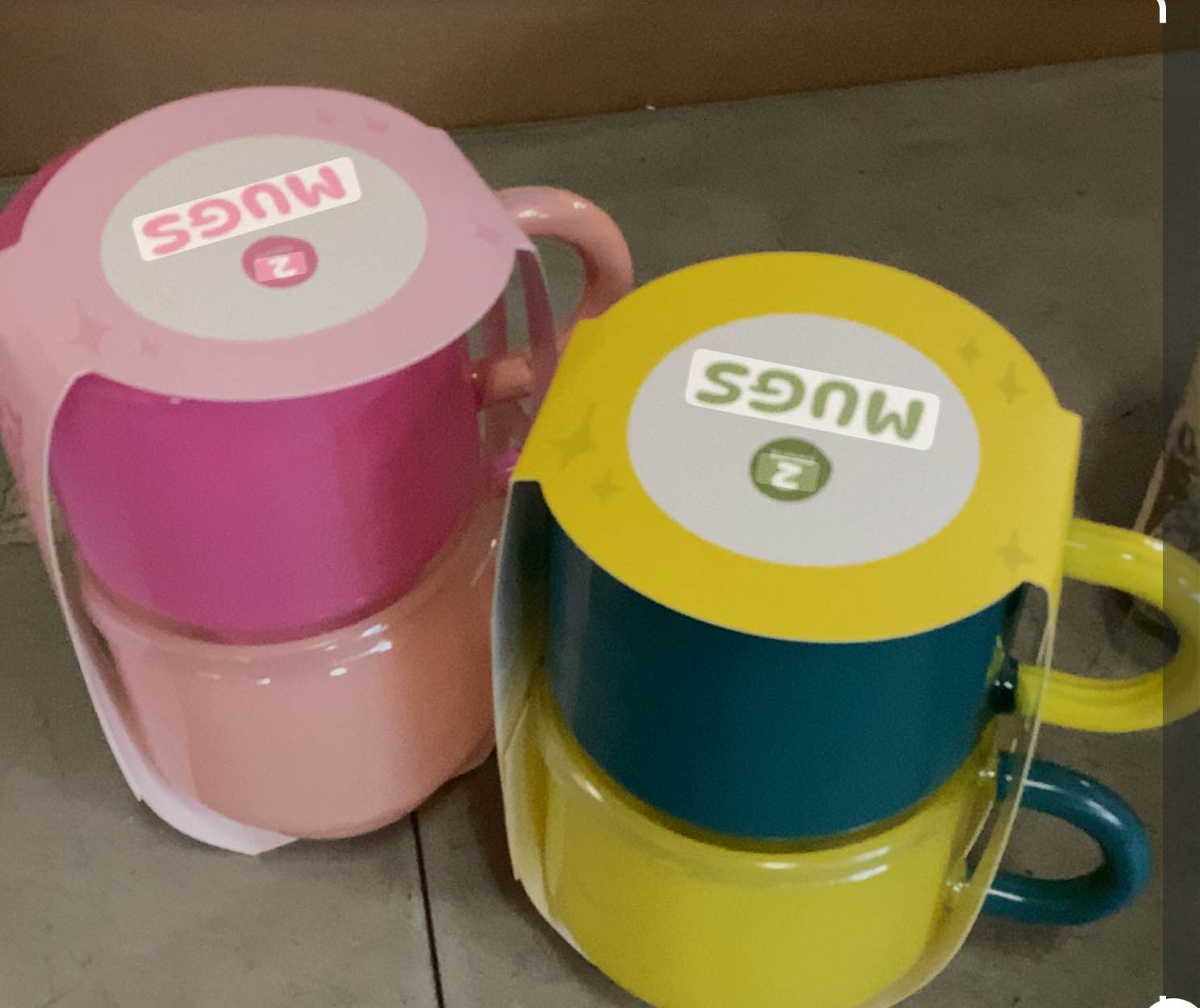 two sets of vintage Tupperware stacking mugs, each containing two mugs, in pink/light pink and yellow/teal color combinations.  