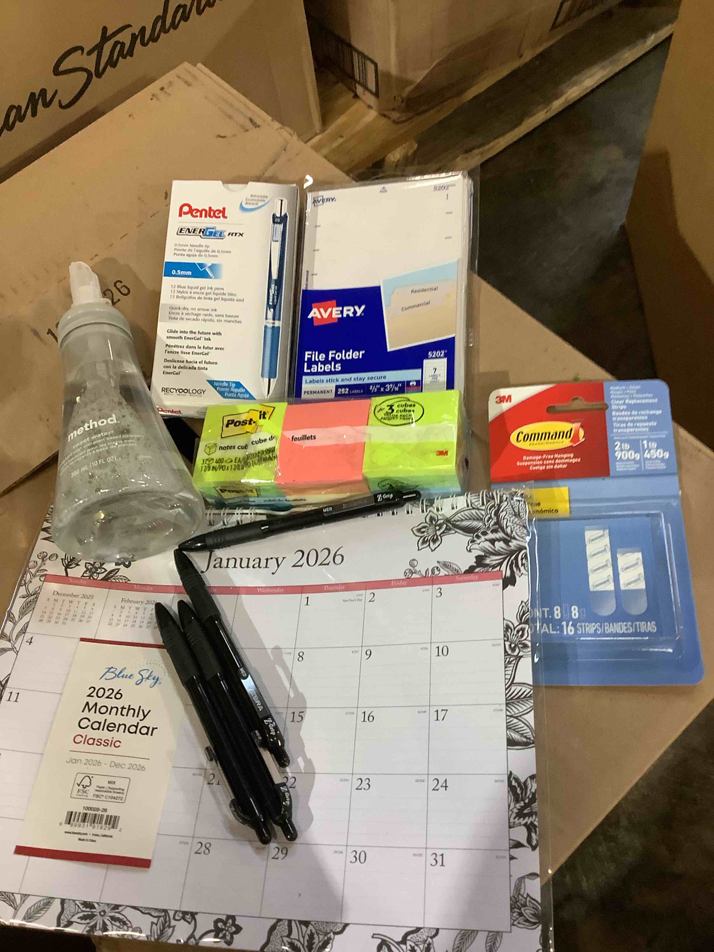 assortment of office supplies and cleaning; penal pins, file folder, labels, Post-it notes, command strips, calendar, and more