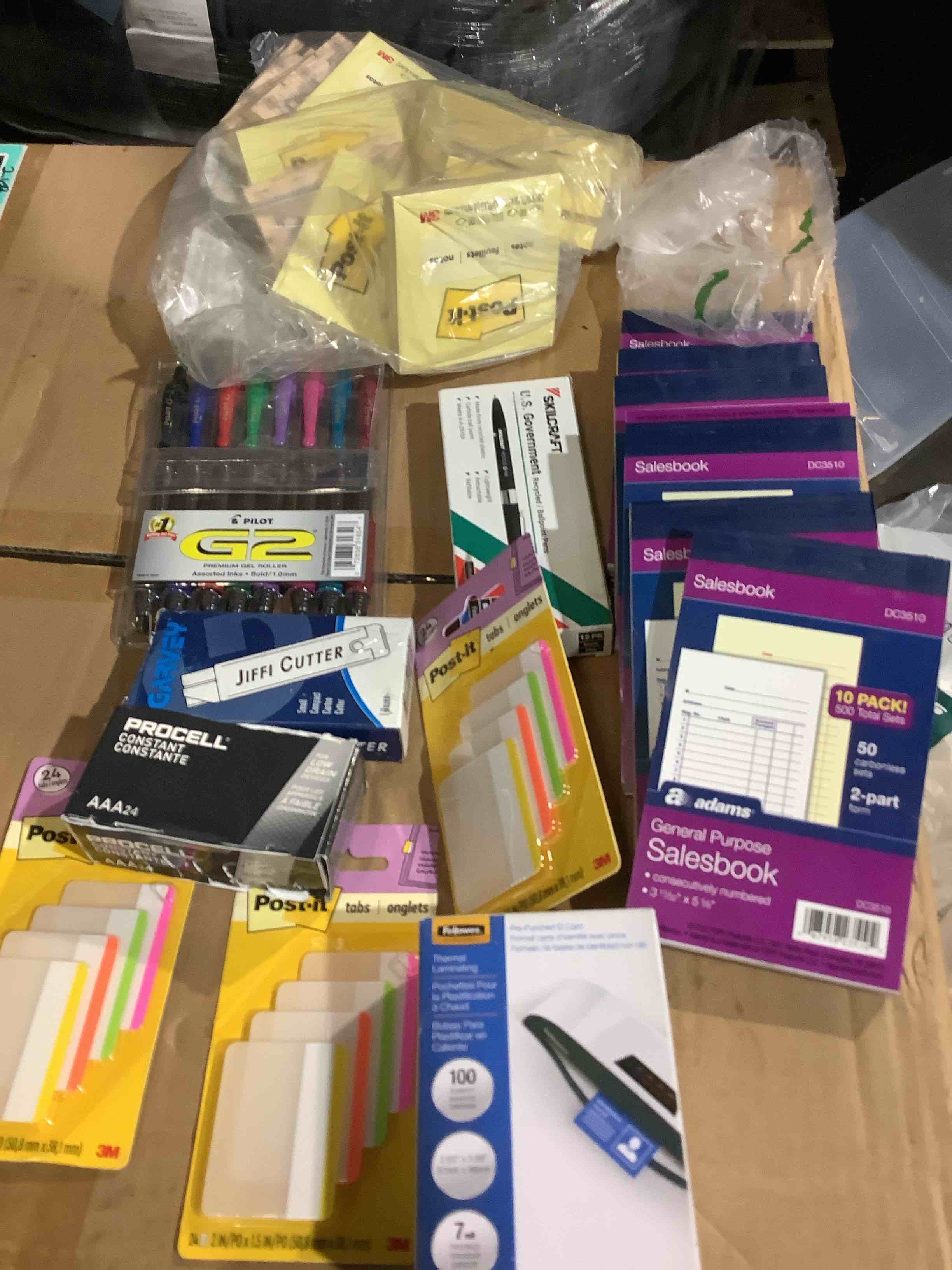 assorted office supplies: post-it notes, jiffy, cutters, sales book, pilot, g2, pens, fellows pre-punch id card, thermal, laminating, and much more