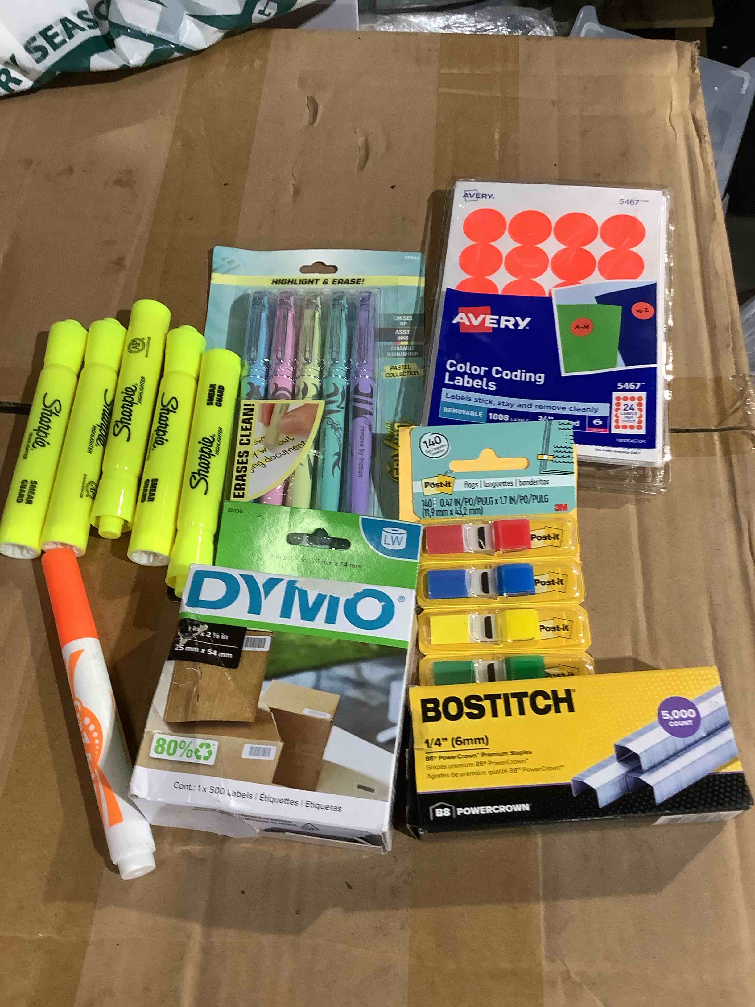 assortment of office supplies: post notes, sharpies highlighters, dymo, color, coding labels, staples, and more