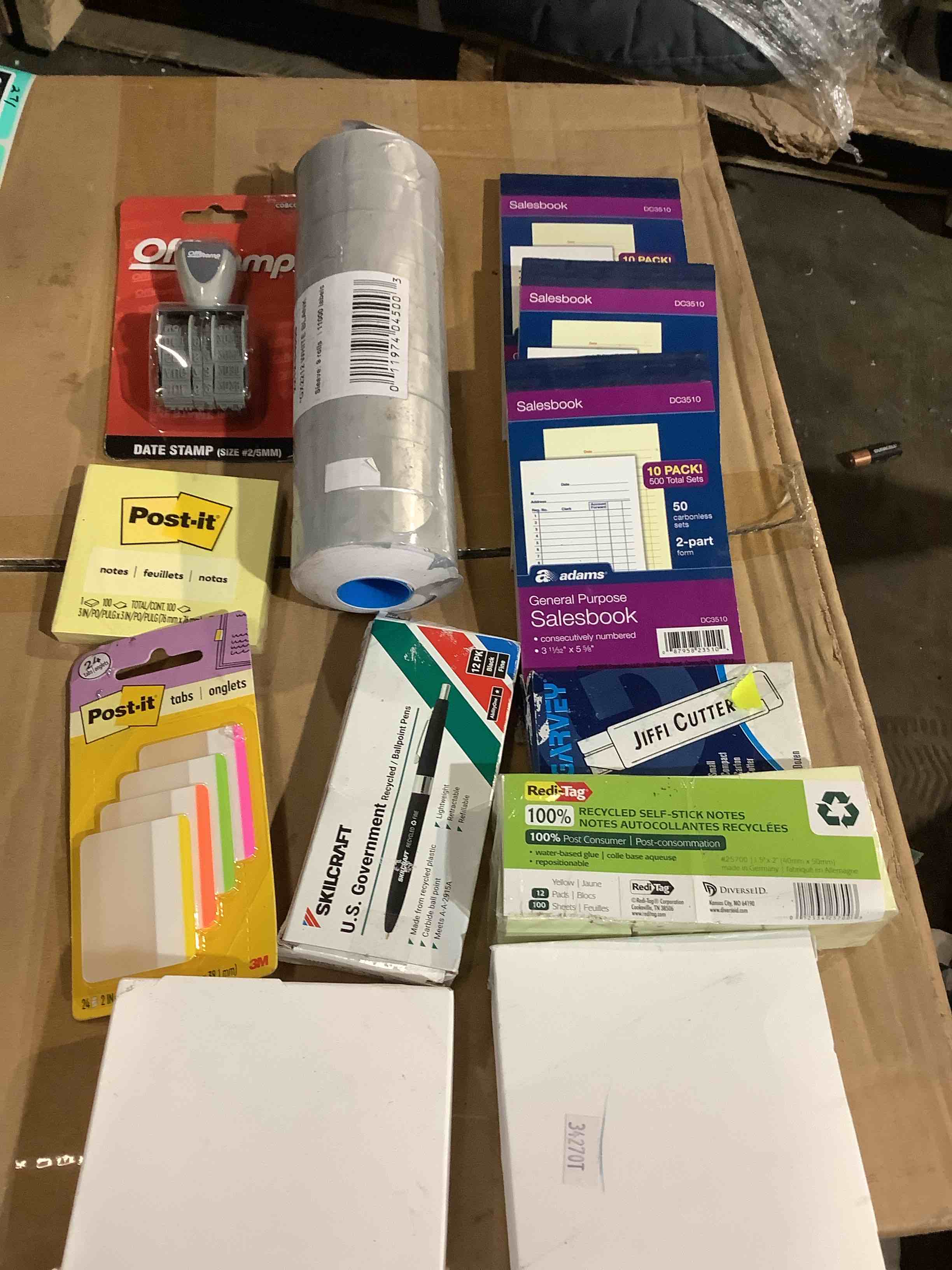 assortment of office supplies: US government pins, skill, craft, sales books, red tag, stick, notes, office stamp, posted it so much more