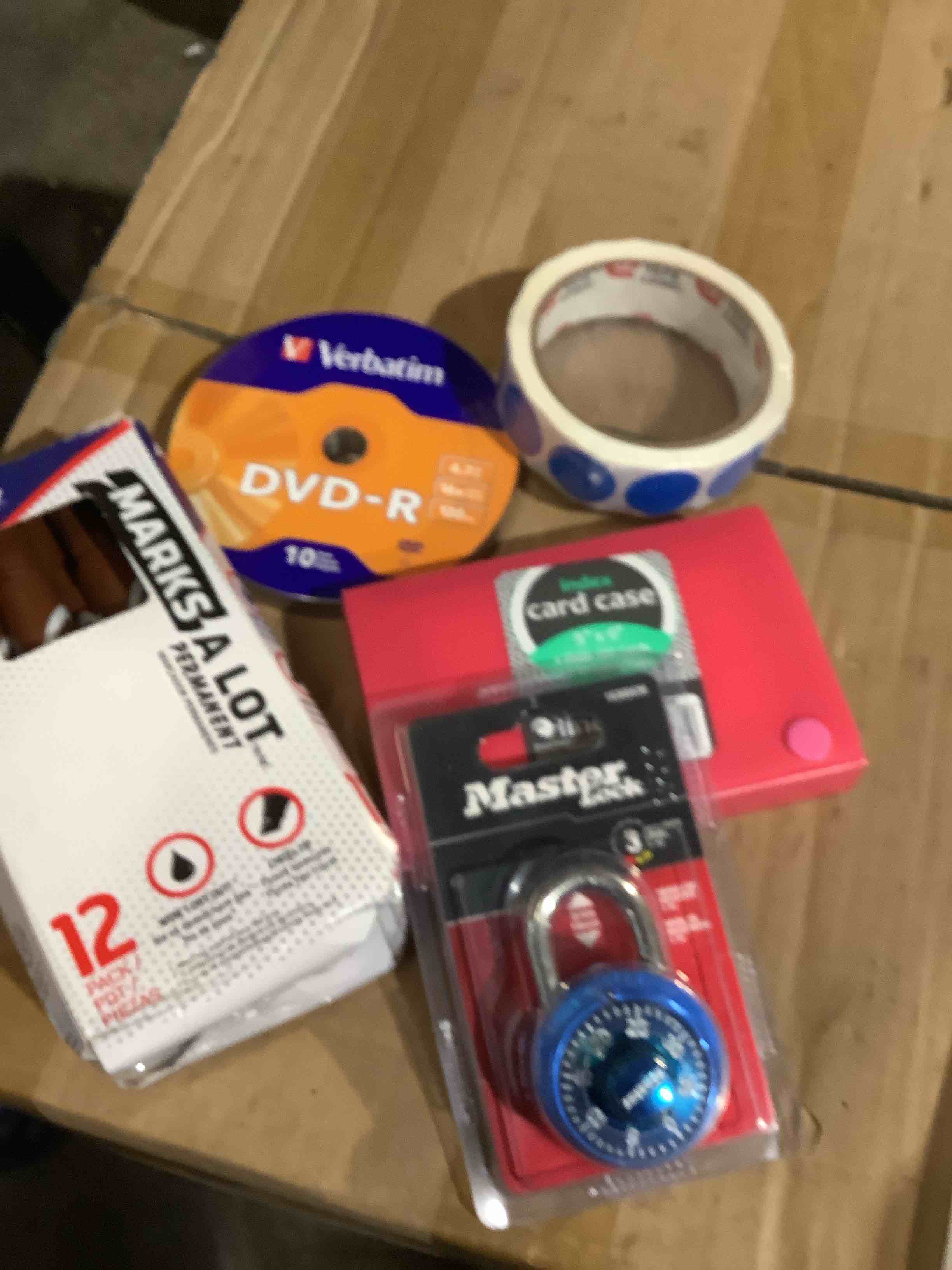 assorted office supplies: brown, permanent markers, master lock, index card case, Verbatim DVD R