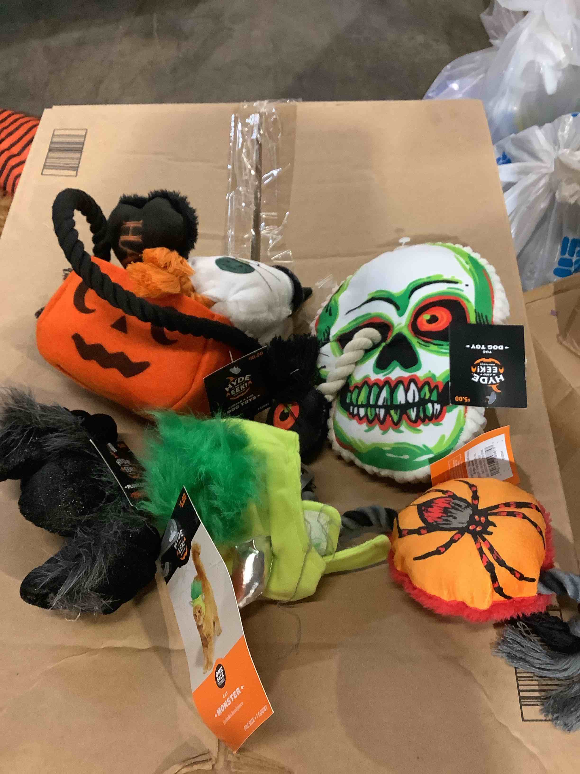 assortment of Halloween dog cat costumes and dog toys
