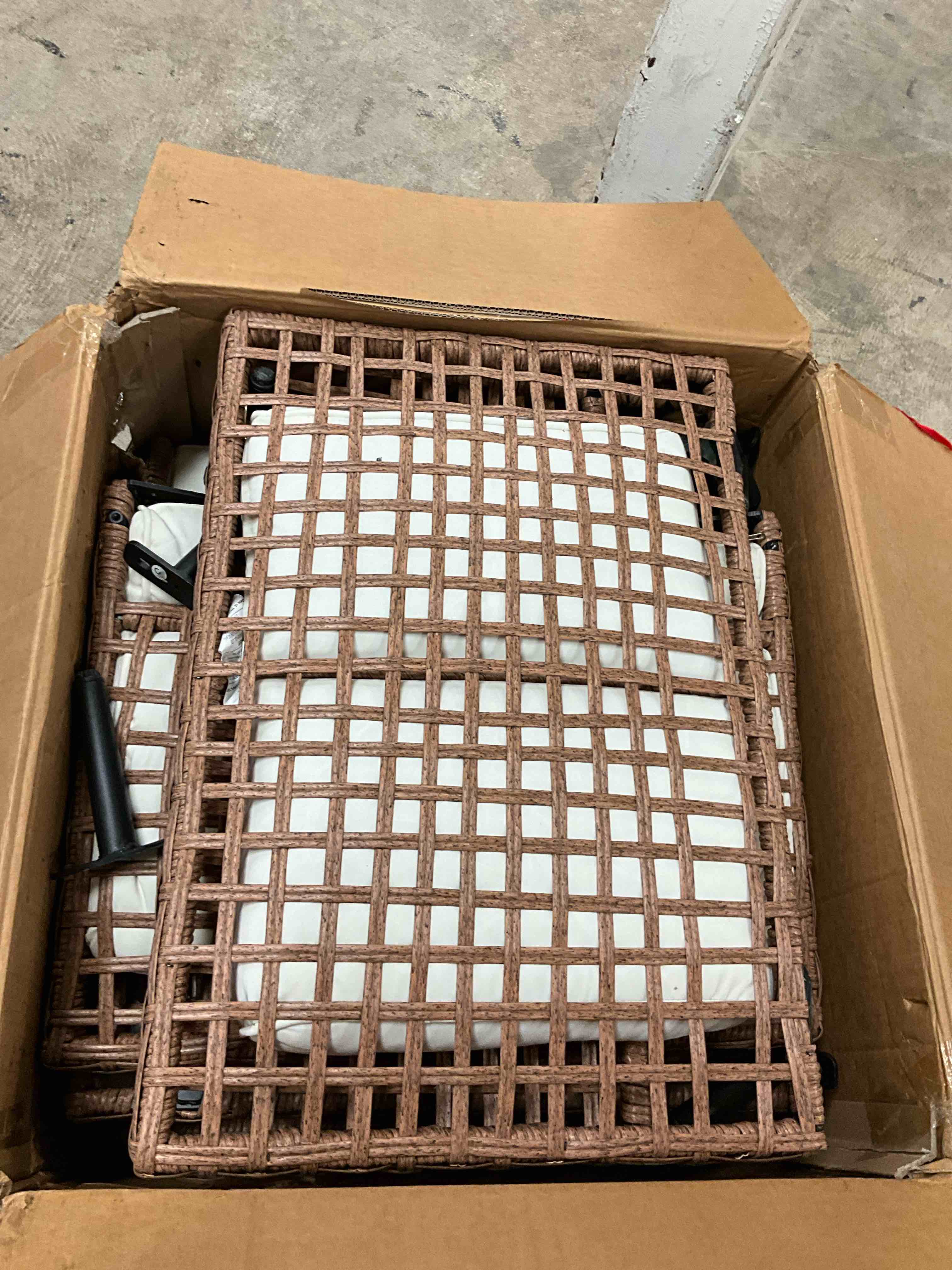 Condition photo showing As Is for brown 7-piece wicker patio conversation set with beige cushions and coffee table (incomplete one box only)