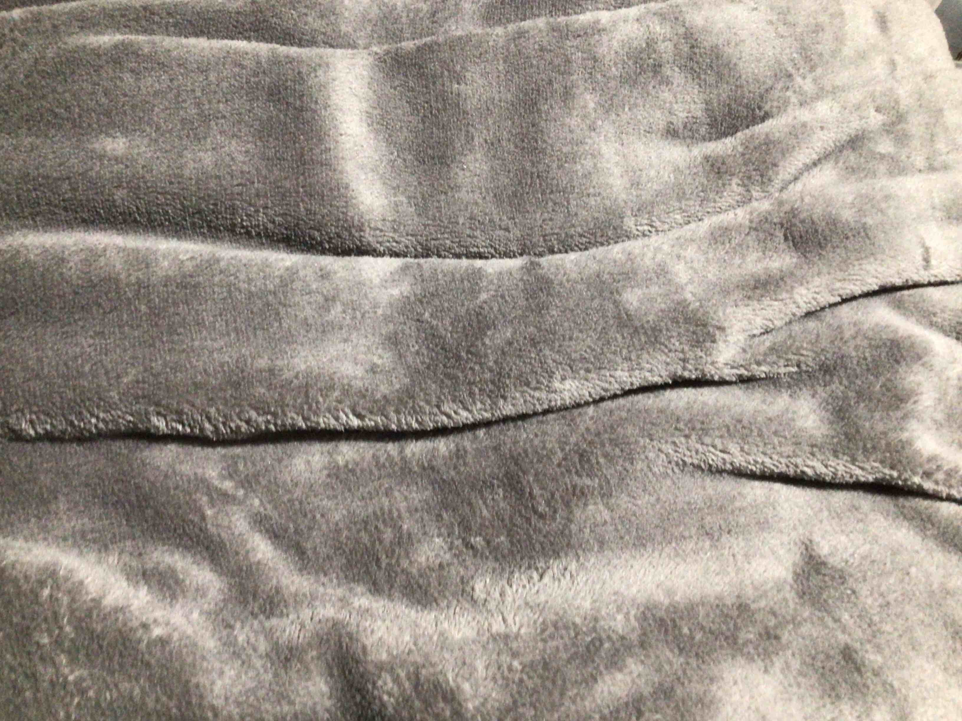 Condition photo showing New/Like New for gray fuzzy blanket