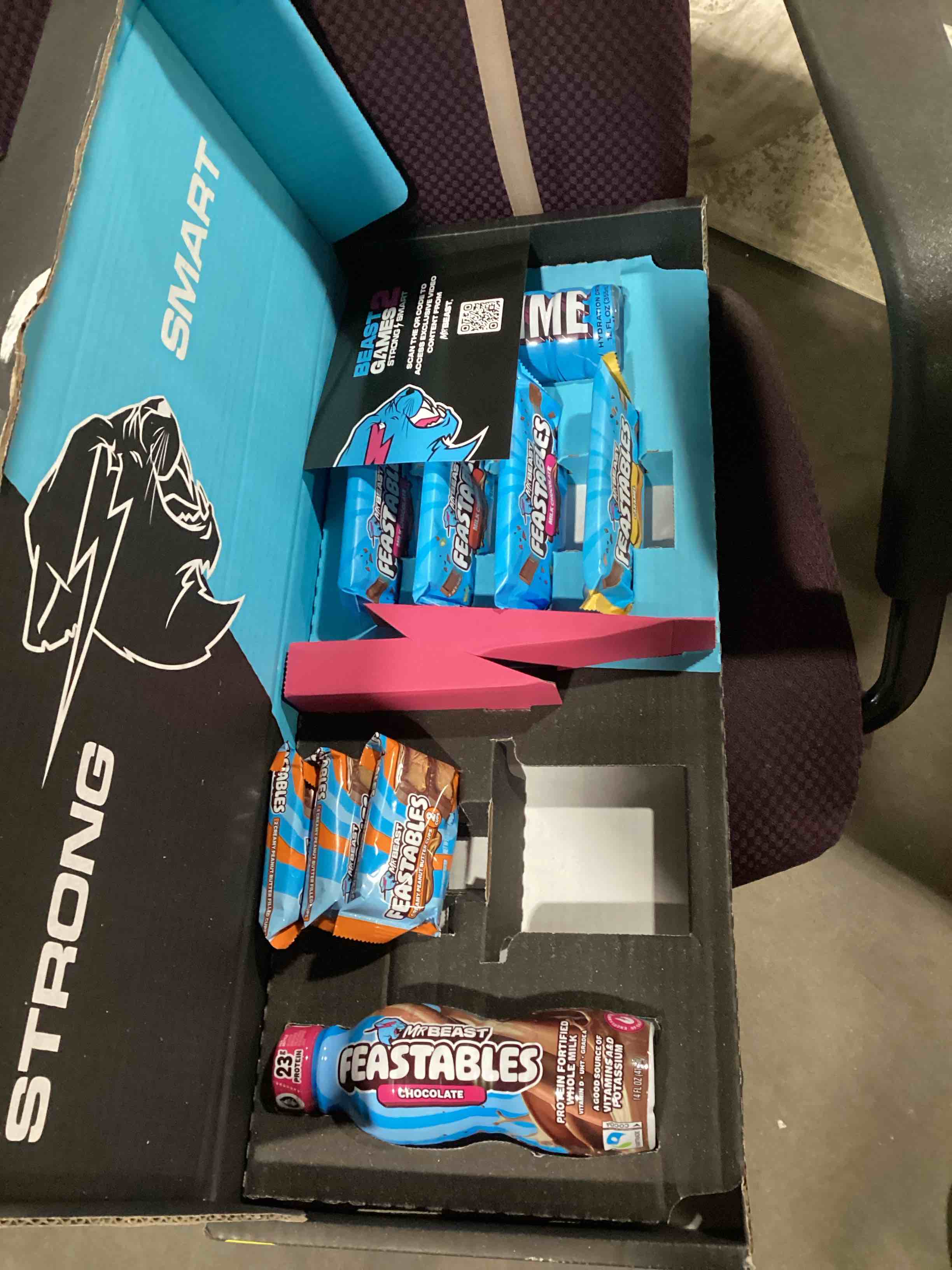 Condition photo showing As Is for feastables beast games season 2 snack bundle, 10 count, mrbeast chocolate bars & cups, protein milk, hydration drink & beef jerky