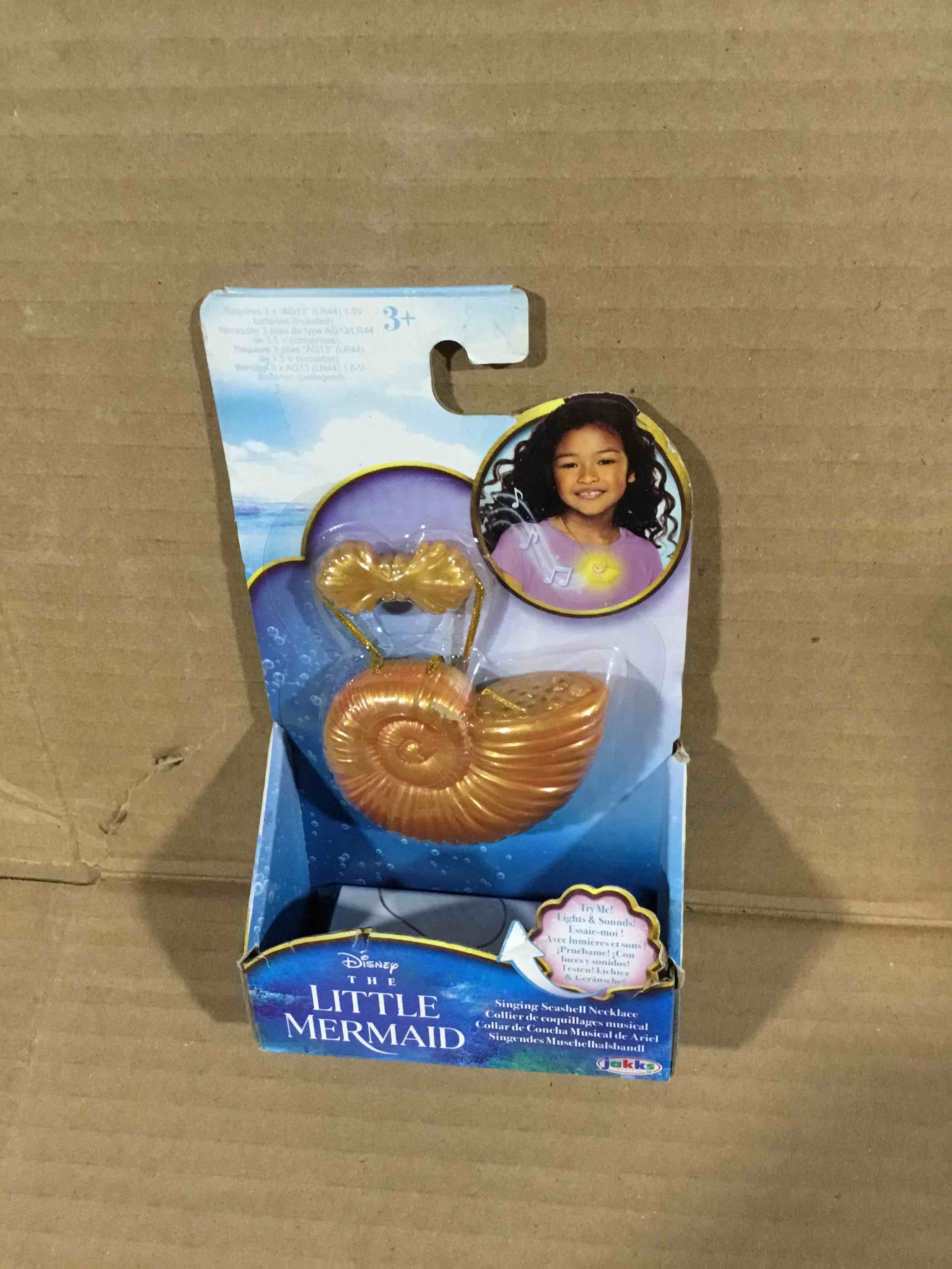 Condition photo showing New/Like New for Disney The Little Mermaid Ariel Seashell Necklace with Light-Up Feature and Ariel's Singing Voice! Toy Necklace for Girls Role Play and Dress-Up Time!