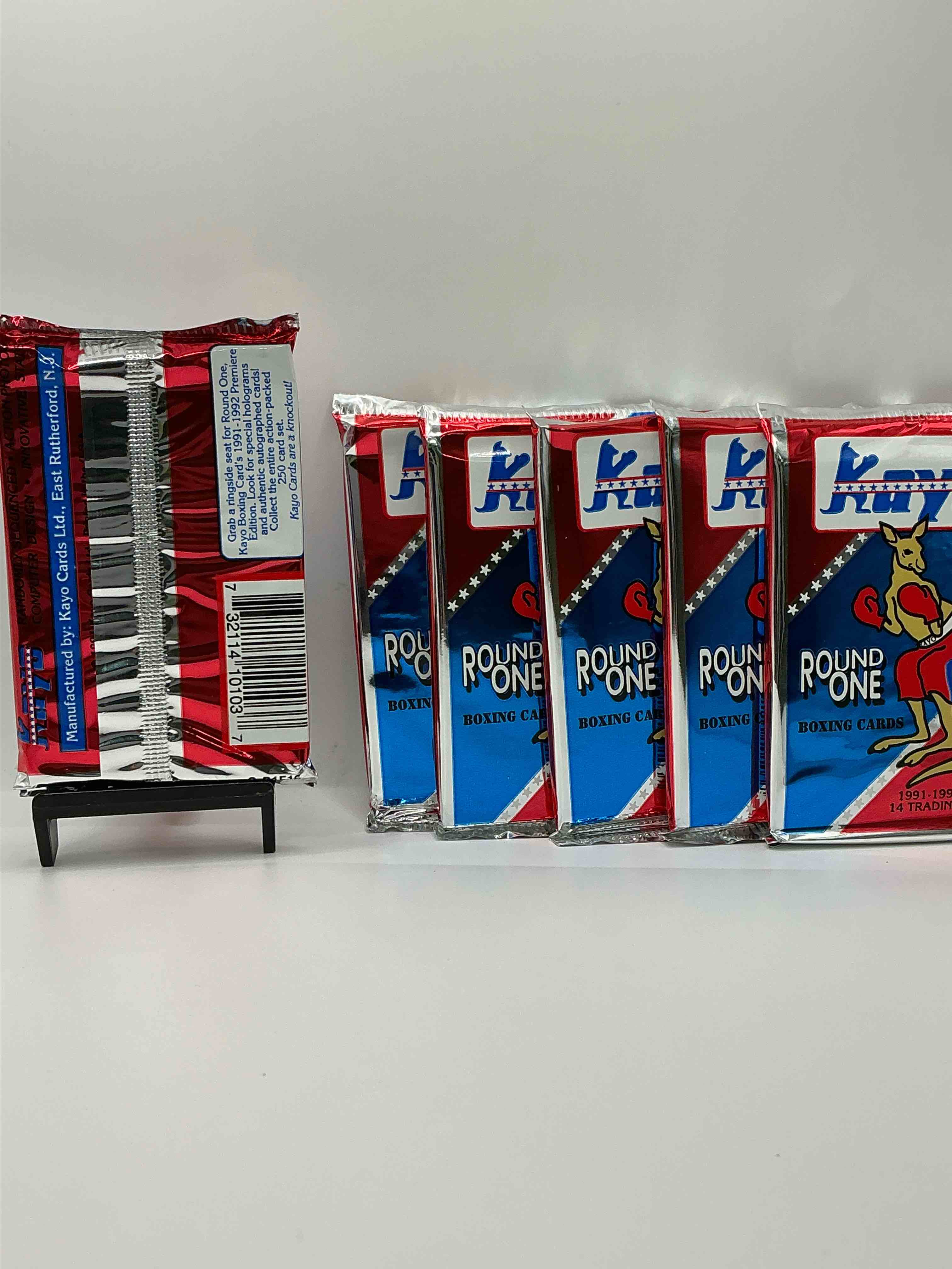 Condition photo showing New/Like New for boxing fans! 1991-92 kayo round one boxing cards! 14 cards per pack! look for roy jones jr, lennox lewis, james toney & more! beautiful packs!