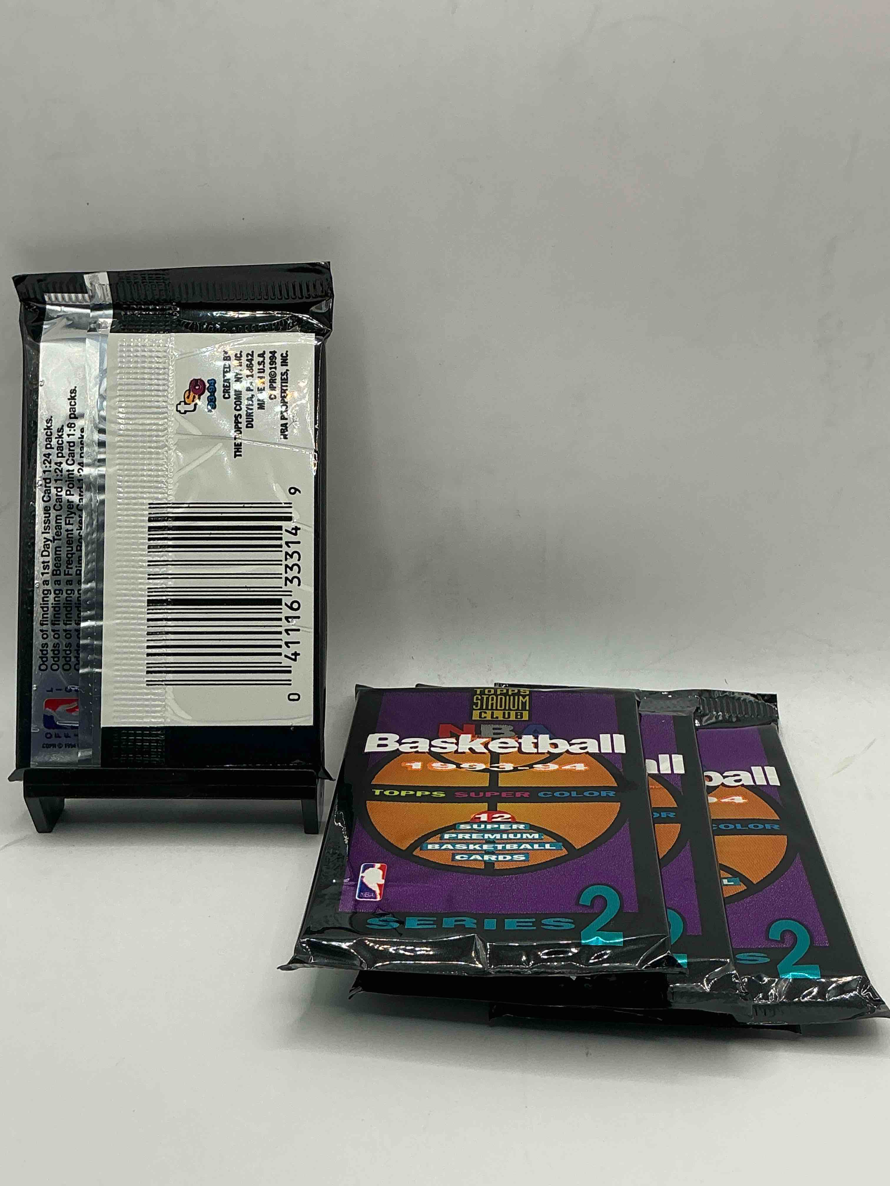 Condition photo showing New/Like New for nba bonanza! 1993- 94 topps stadium club series ii basketball packs! 12 premium basketball cards in each pack! search for legends & rookies alike! look for michael jordan, shag o'nell, hakeem olajuwon & more ist day issue cards, frequent flyer cards, members only cards & rookies from hardaway & webber! possible pippen, magic, jordan, robinson, shaq, olajuwon, ewing & so much more!