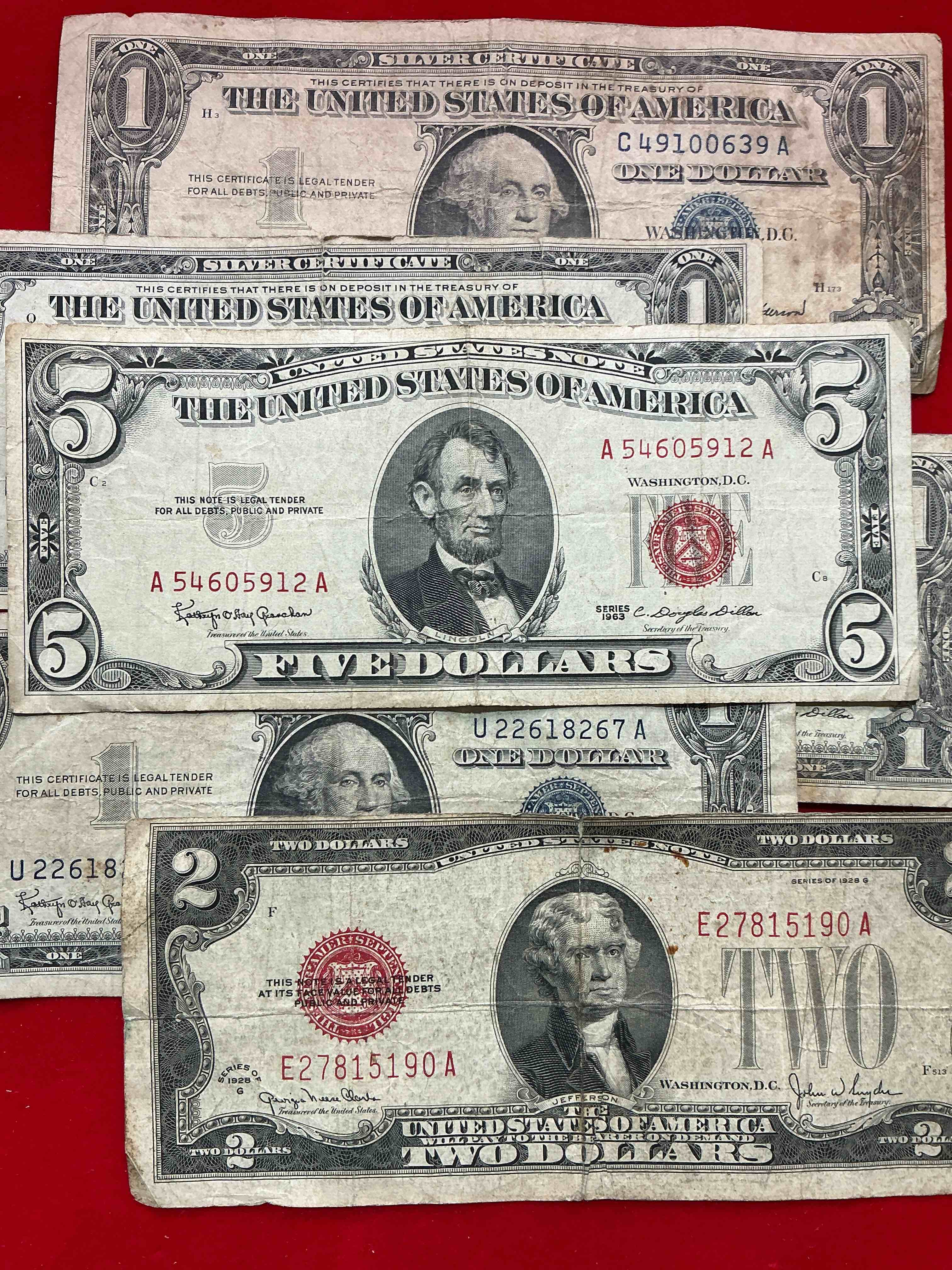 Condition photo showing Good Condition for rare american dollar bills! red seal five dollar bill & red seal two dollar bill, along with silver certificates! five dollar bill ultra rare & in good condition, red seal two dollar bill in good condition & silver certificates produced from 1878 to 1964 & are still considered legal tender at face value. here are gorgeous, circulated 1935 & 1957 u.s. one dollar silver certificate, with highly collectible "blue seal!* own an awesome piece of history! american dollar lot! 