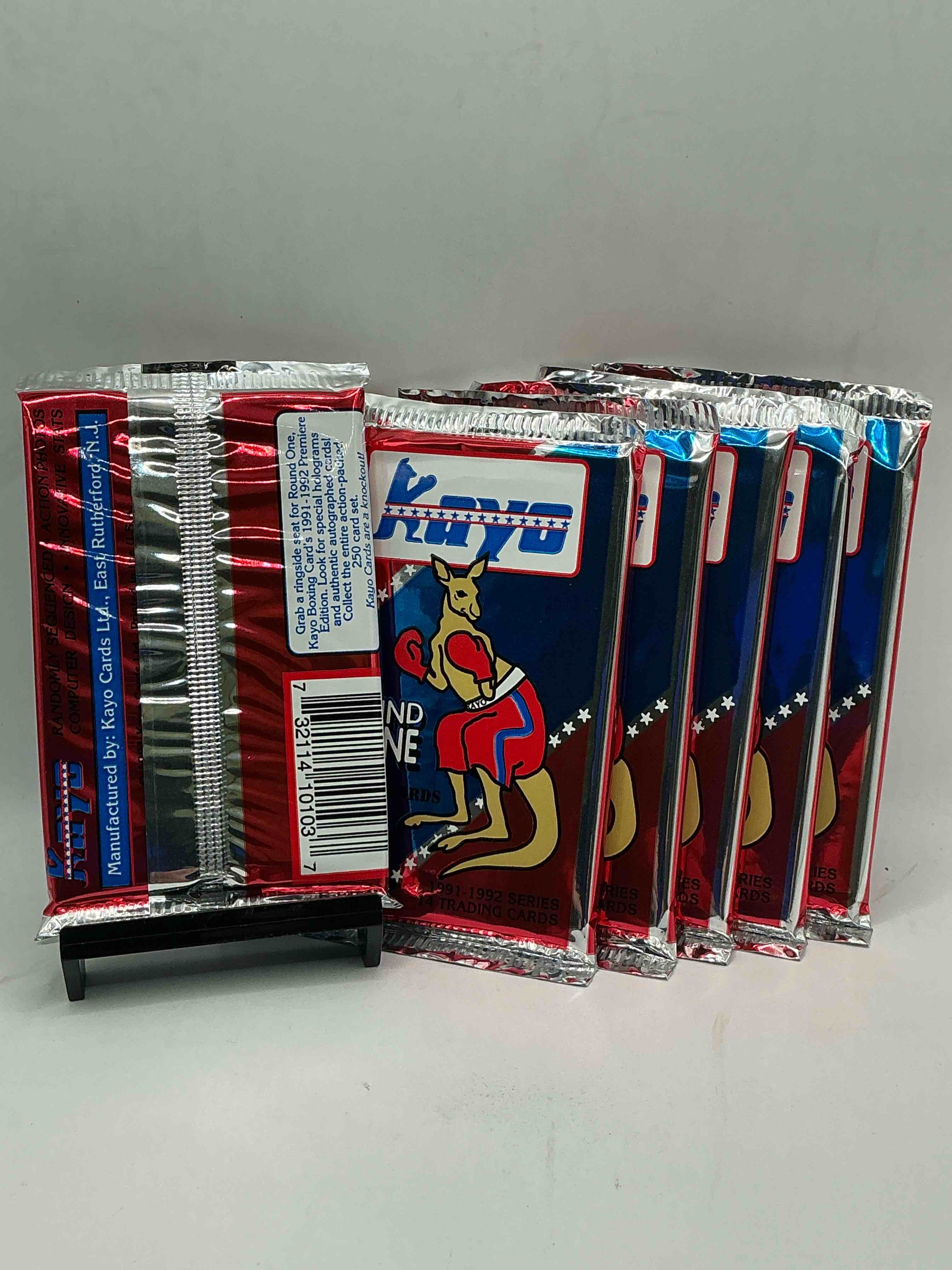 Condition photo showing New/Like New for 1991-92 kayo round one boxing cards! 14 cards per pack! look for roy jones jr, lennox lewis, james toney & more! beautiful packs!