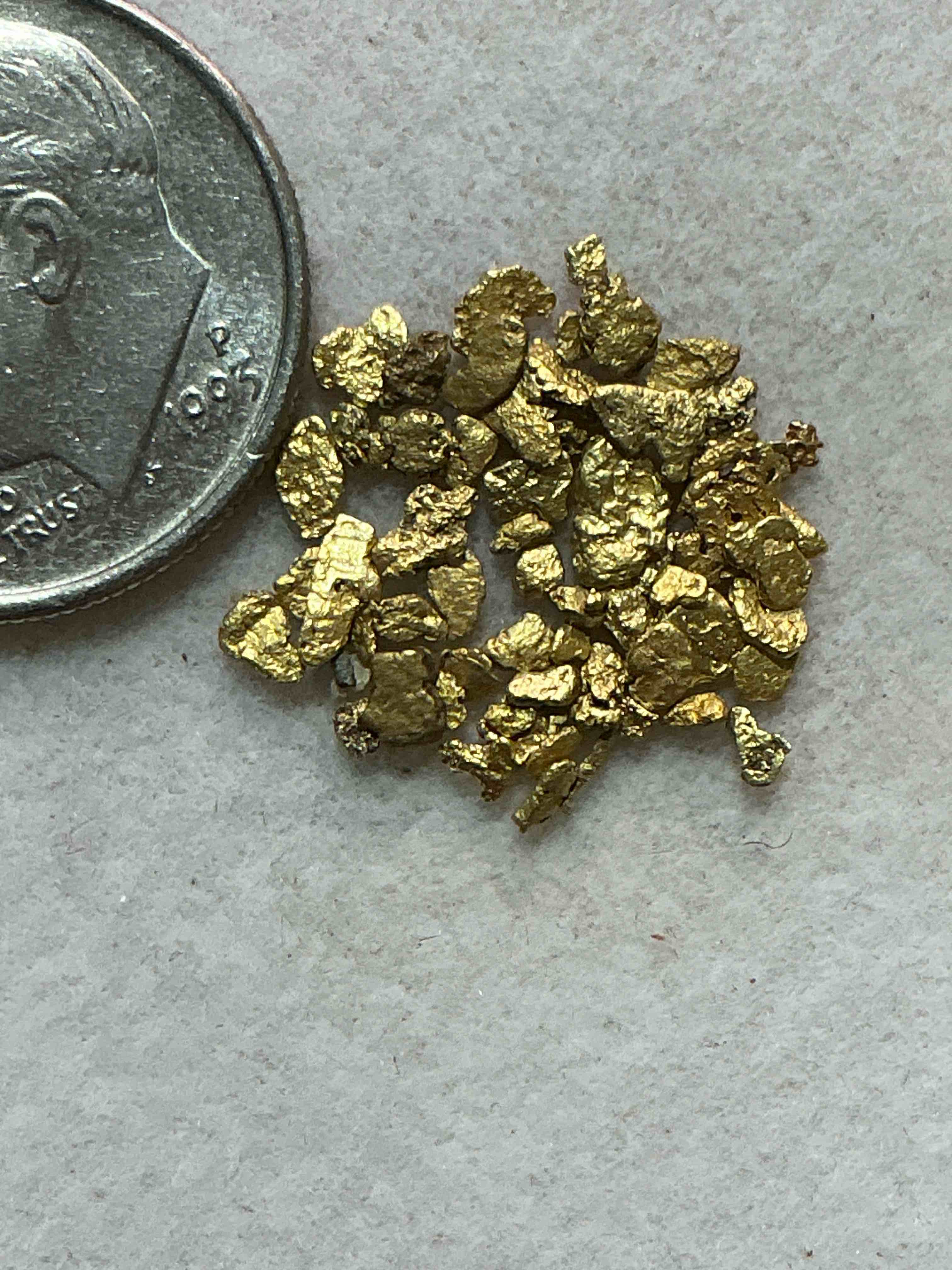 Condition photo showing New/Like New for genuine gold nuggets! approximately 1 gram of prospected gold nuggets! gold nuggets fresh from prospecting north carolina mountains, total weight of all nuggets is approximately 1 gram! these gold nuggets test at between approx 22-24 karat. gold in raw, prospected form is extremely hard to find & much rarer than any refined form. get in on the gold craze... gold has increased in value over 40% since 2025! u.s. dime for size reference only (not included). case in image included. own genuine, gold nuggets!