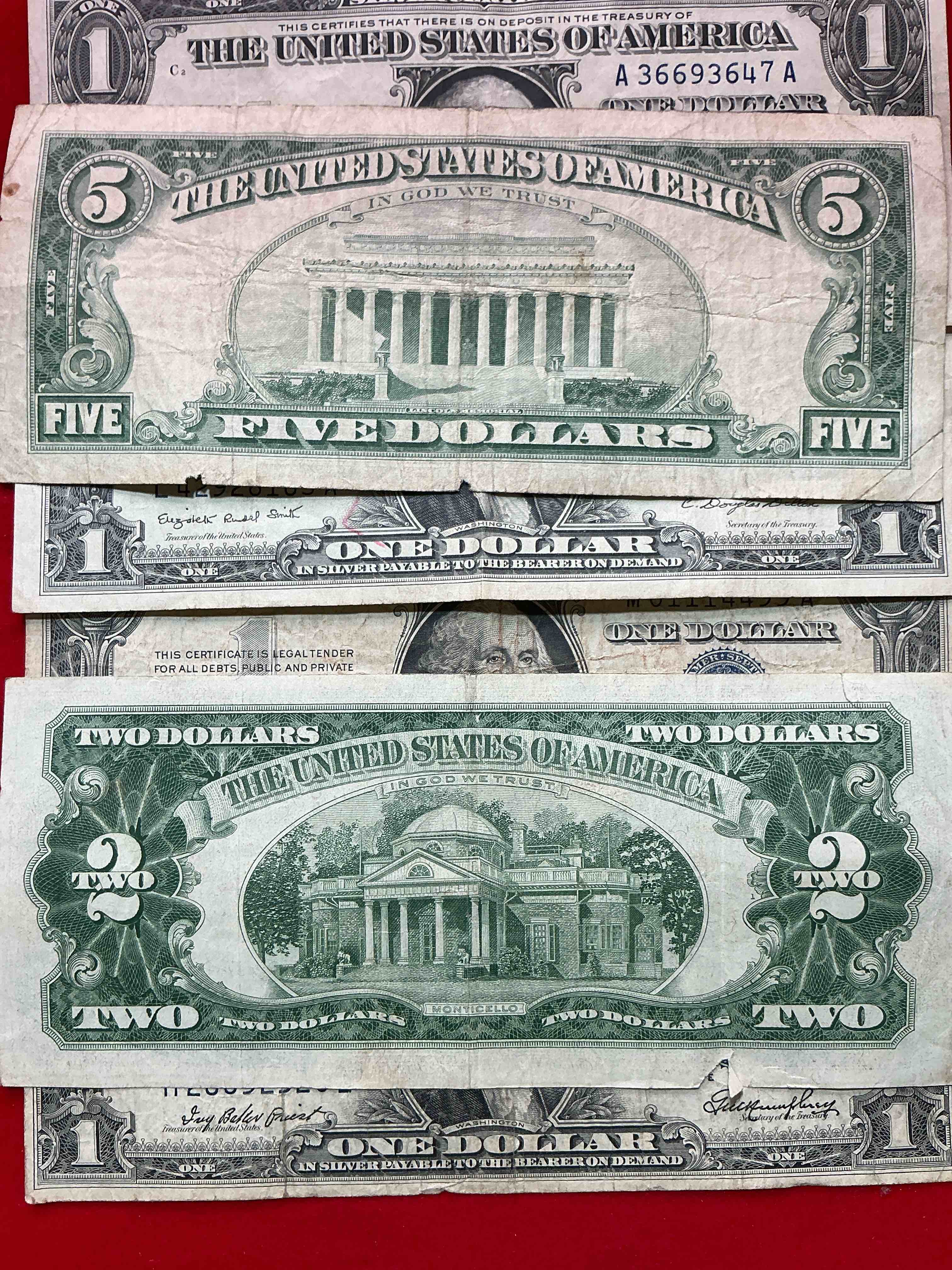 Condition photo showing Good Condition for rare american dollar bills! red seal five dollar bill & red seal two dollar bill, along with silver certificates! five dollar bill ultra rare & in good condition, red seal two dollar bill in good condition & silver certificates produced from 1878 to 1964 & are still considered legal tender at face value. here are gorgeous, circulated 1935 & 1957 u.s. one dollar silver certificate, with highly collectible "blue seal!* own an awesome piece of history! american dollar lot!