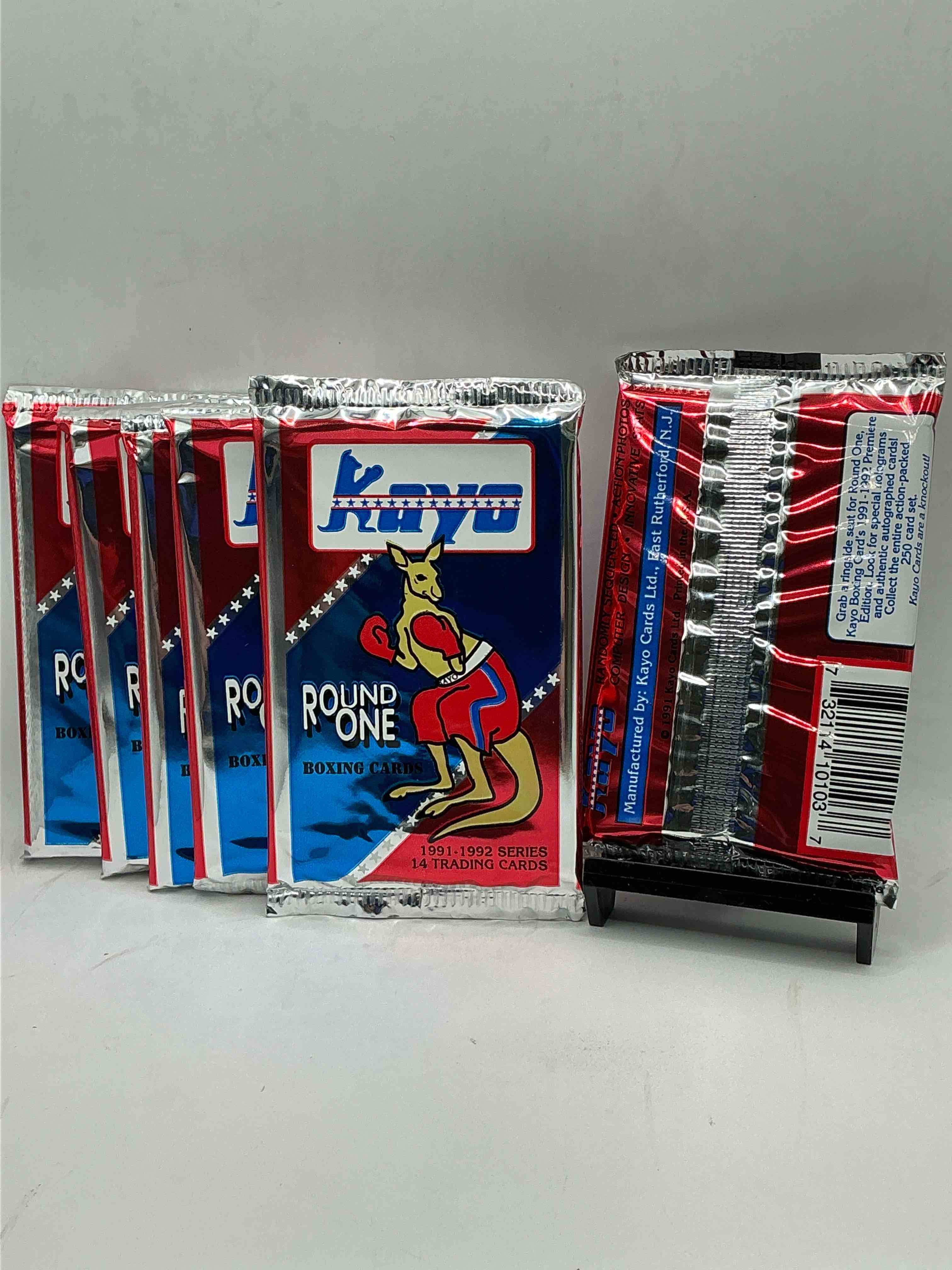Condition photo showing New/Like New for 1991-92 kayo round one boxing cards! 14 cards per pack! look for roy jones jr, lennox lewis, james toney & more! beautiful packs!