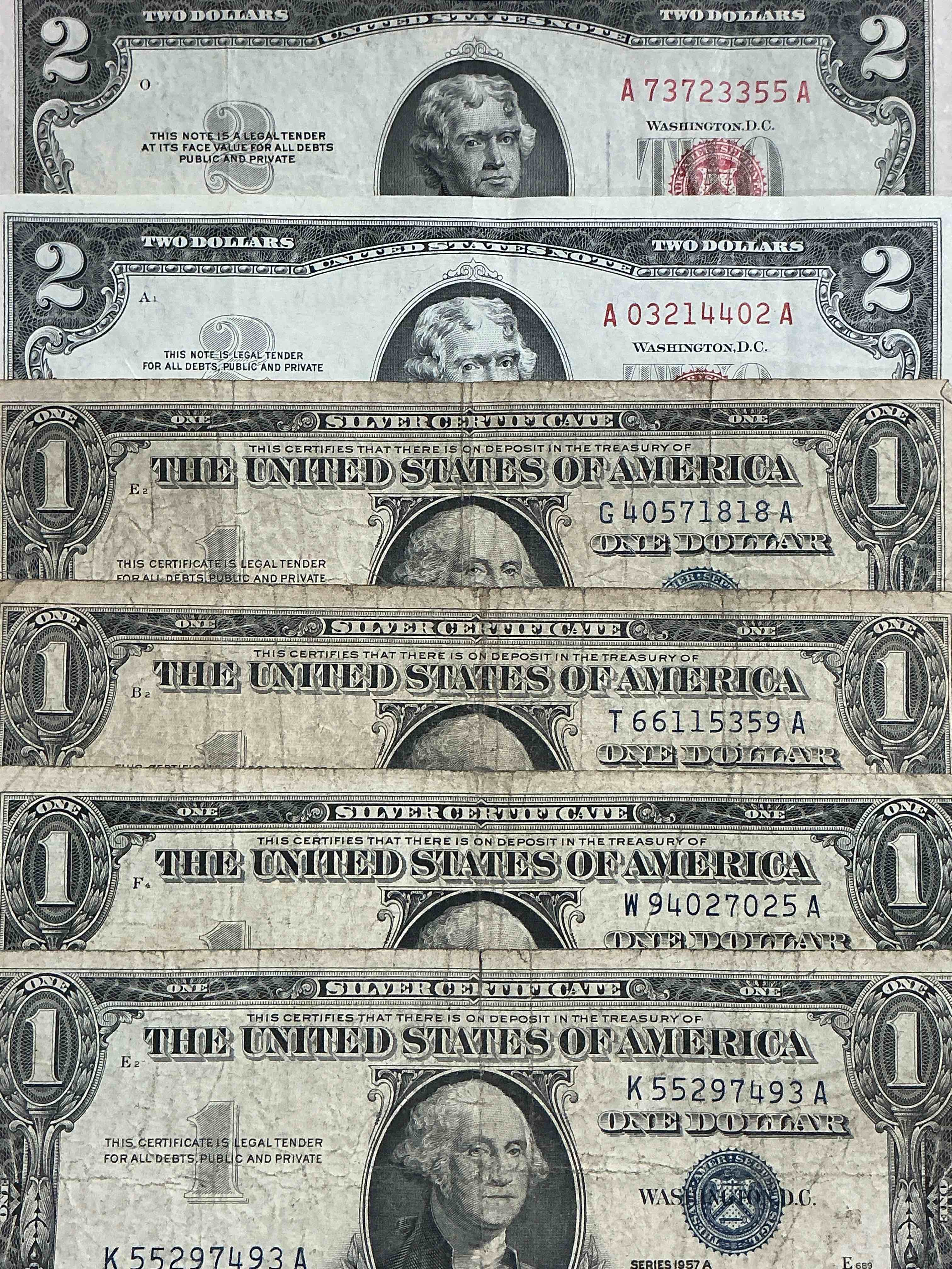 Condition photo showing Good Condition for rare american dollar bills! red seal two dollar bill, along with silver certificates! red seal two dollar bill in good condition & silver certificates produced from 1878 to 1964 & are still considered legal tender at face value. here are gorgeous, circulated 1935 & 1957 series u.s. one dollar silver certificate, with highly collectible "blue seal!* own an awesome piece of history! american dollar lot! 