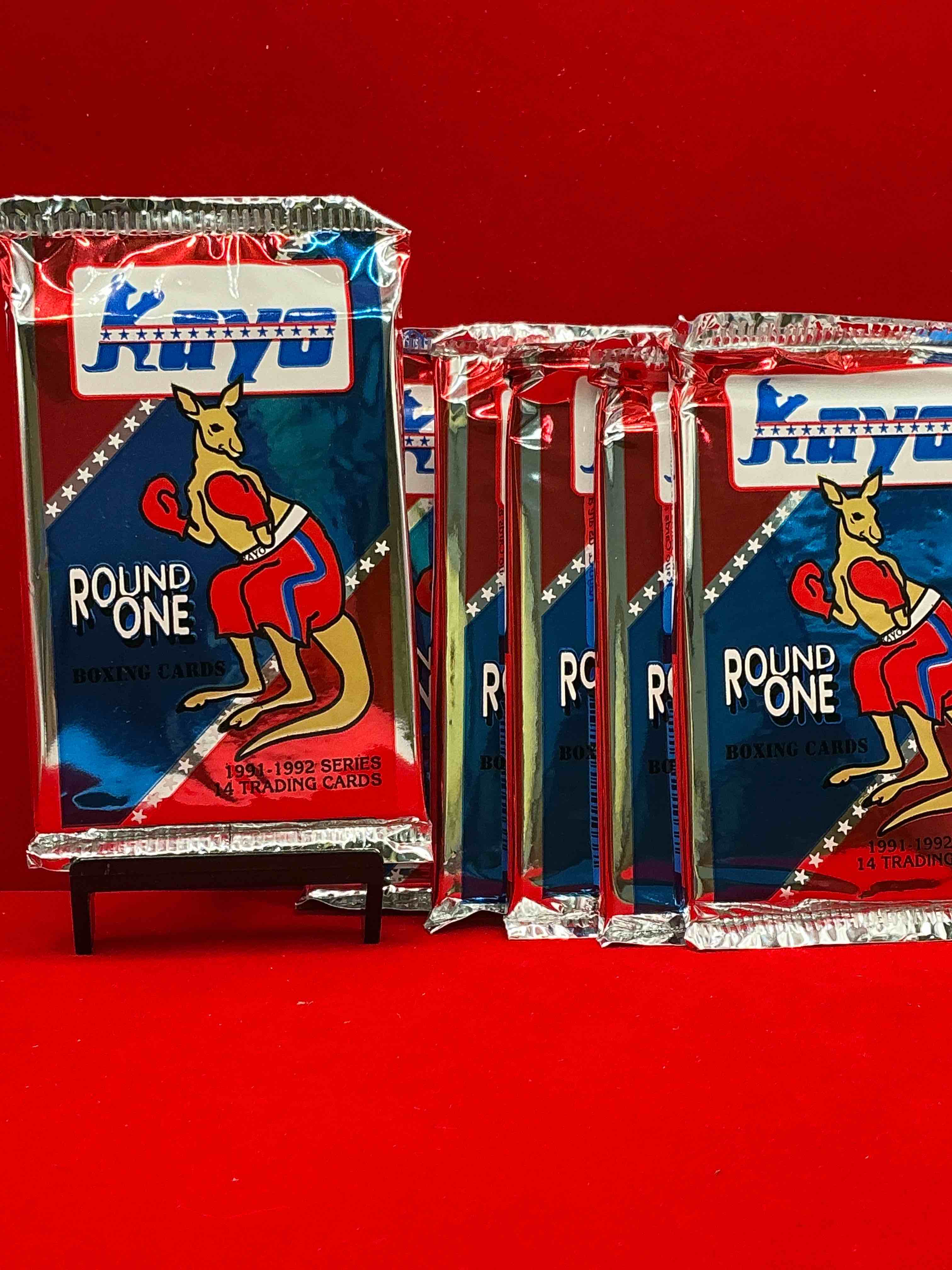 Condition photo showing New/Like New for 1991-92 kayo round one boxing cards! 14 cards per pack! look for muhammad ali, roy jones jr, lennox lewis, james toney & more! beautiful packs!