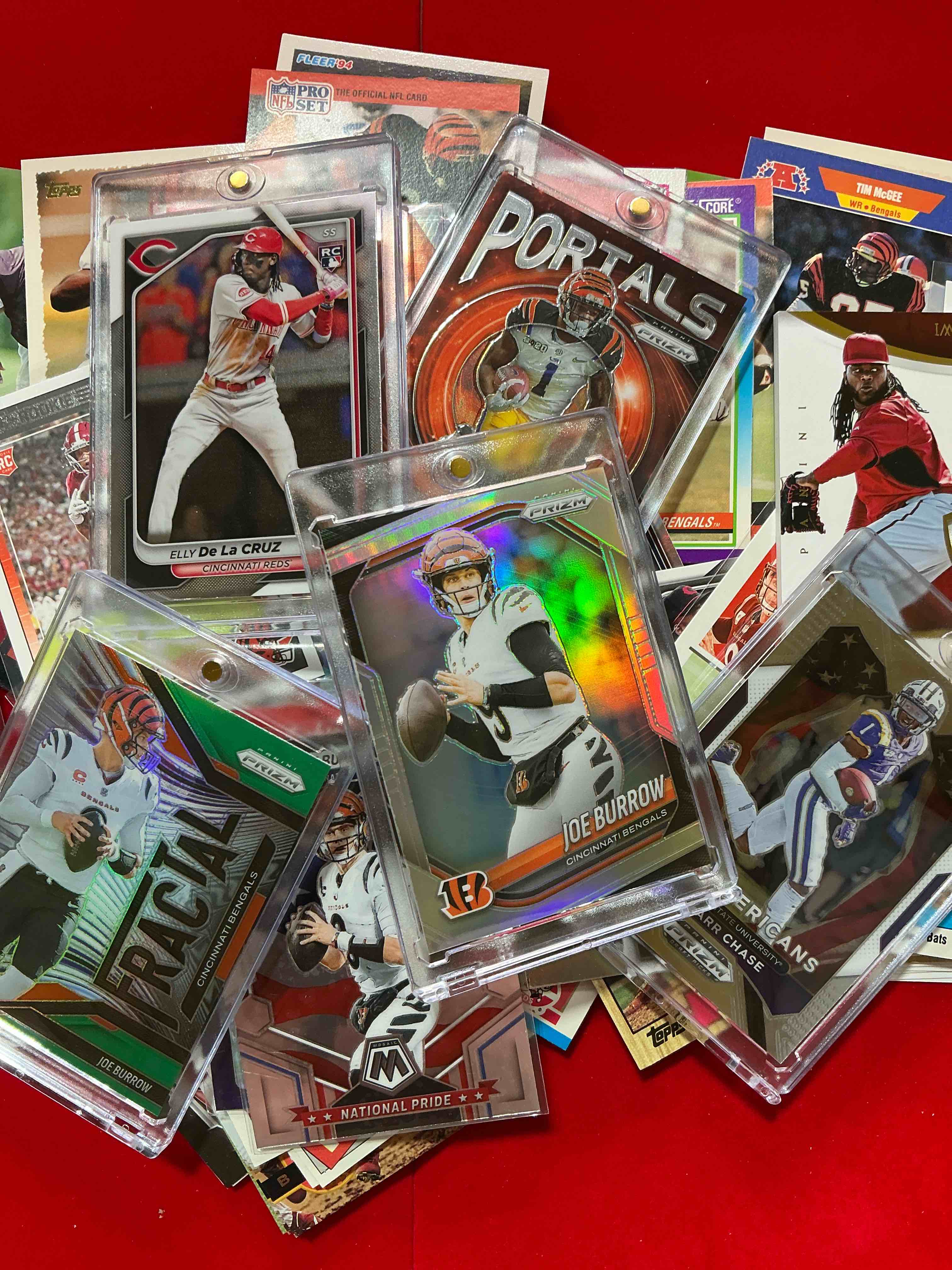 Cincinnati Craziness!  100 Awesome Cincinnati Bengals & Cincinnati Reds Player Sports Cards, Football & Baseball!   Featuring Joe Burrow & Rookie, Numbered Cards & More! A Great Mix Of Hall Of Famers & So Much More!  This 100 Card Lot Features Cincinnati Player Cards In Excellent Condition From Many Decades & Genres With Key Cards In Protective Cases!  Hard To Collect! 