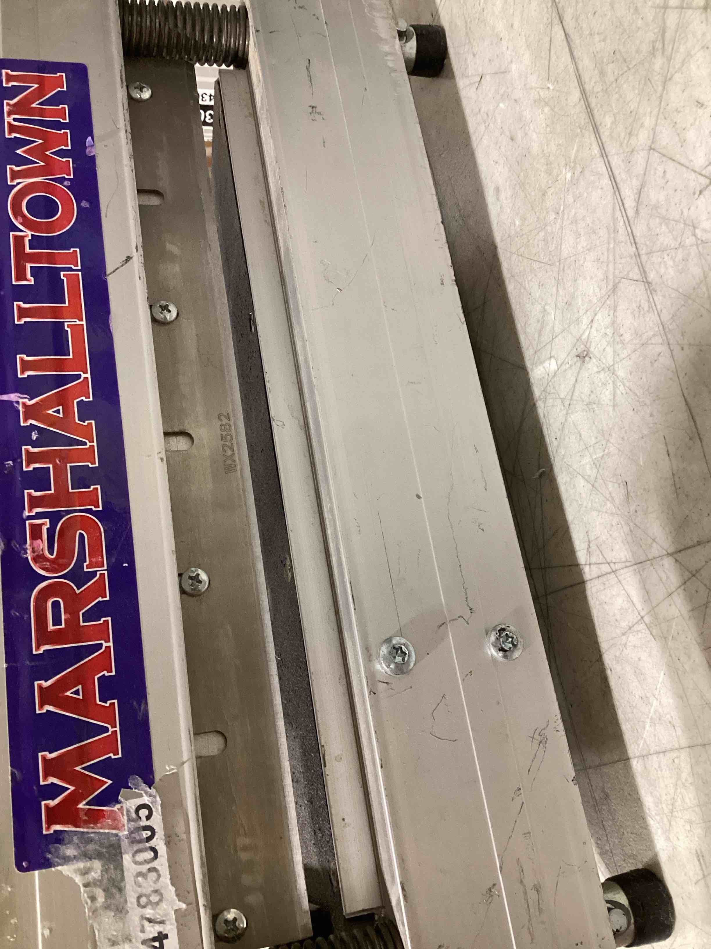 Condition photo showing As Is for marshalltown ultra-lite flooring cutter 9", made in the usa, cuts vinyl plank, laminate, engineered hardwood, siding, and more - honing stone included 9 inch