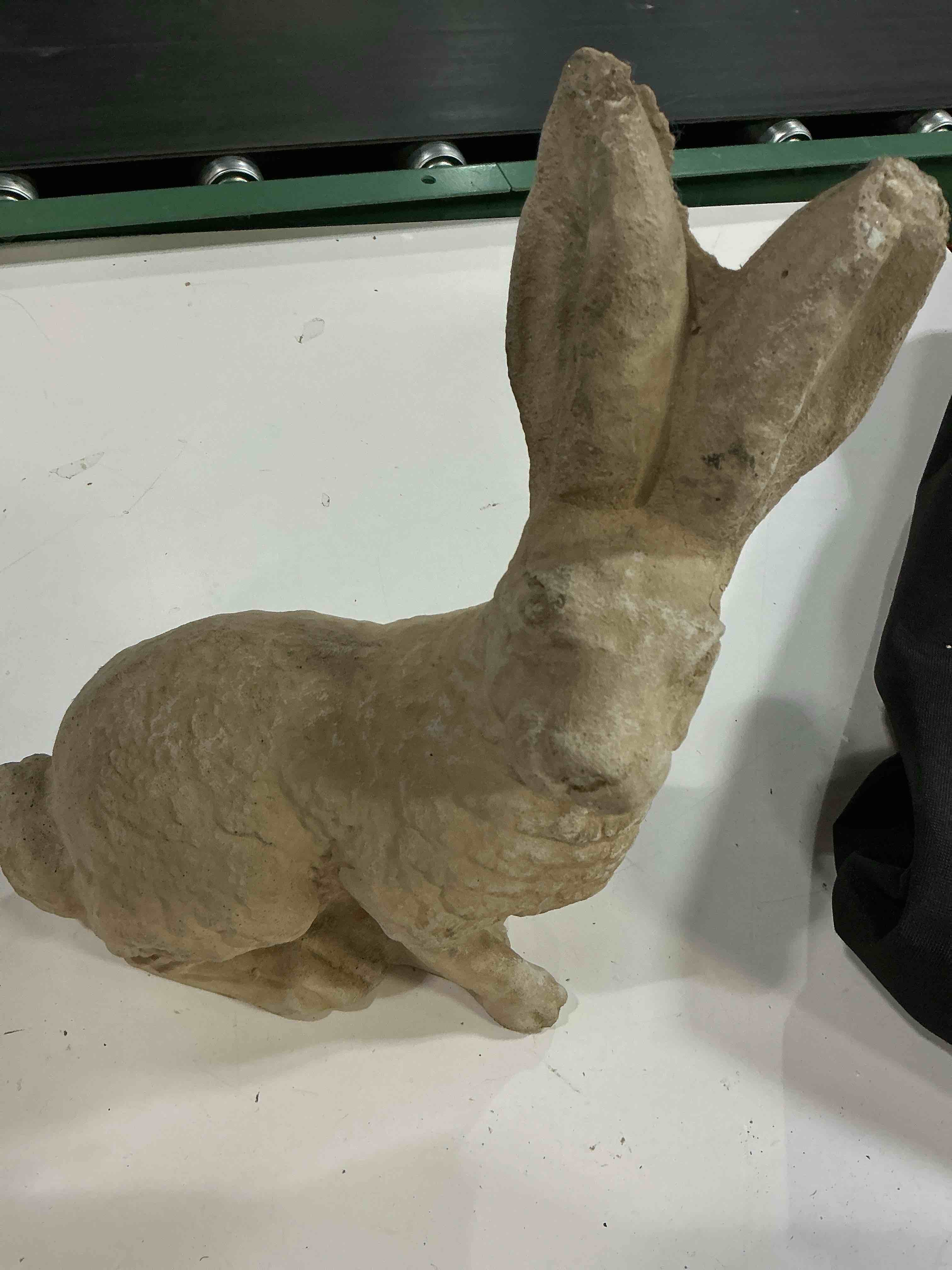 Condition photo showing As Is for concrete rabbit garden statues