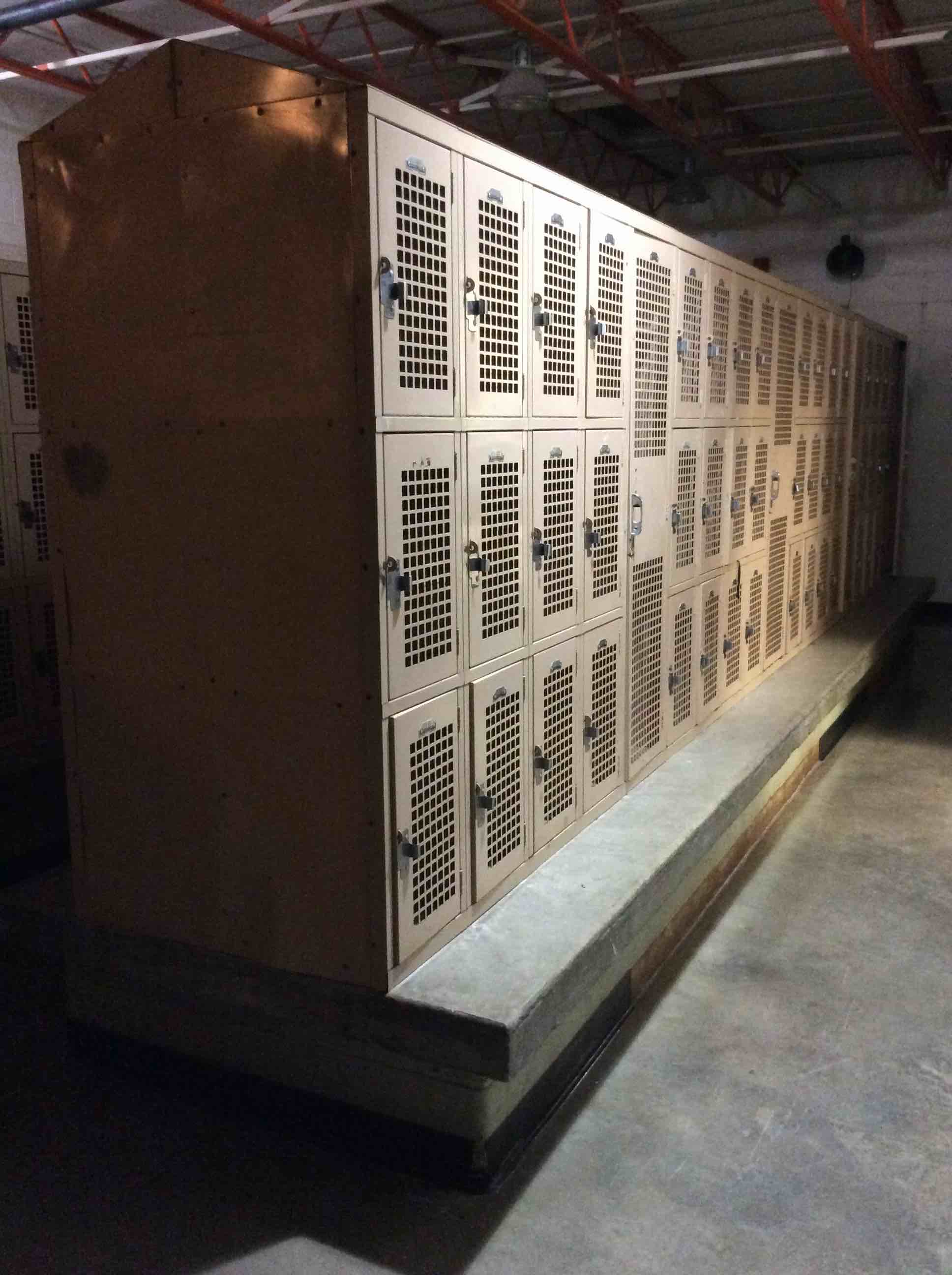 GIRLS’ LOCKER ROOM, CONTENTS TO INCLUDE: (6 SETS) 21-FEET SECTIONS OF LOCKERS (1 SET) 10-FEET SECTION OF LOCKERS, (24) LIGHT FIXTURES, TACK BOARD, WATER FOUNTAIN, DOOR 