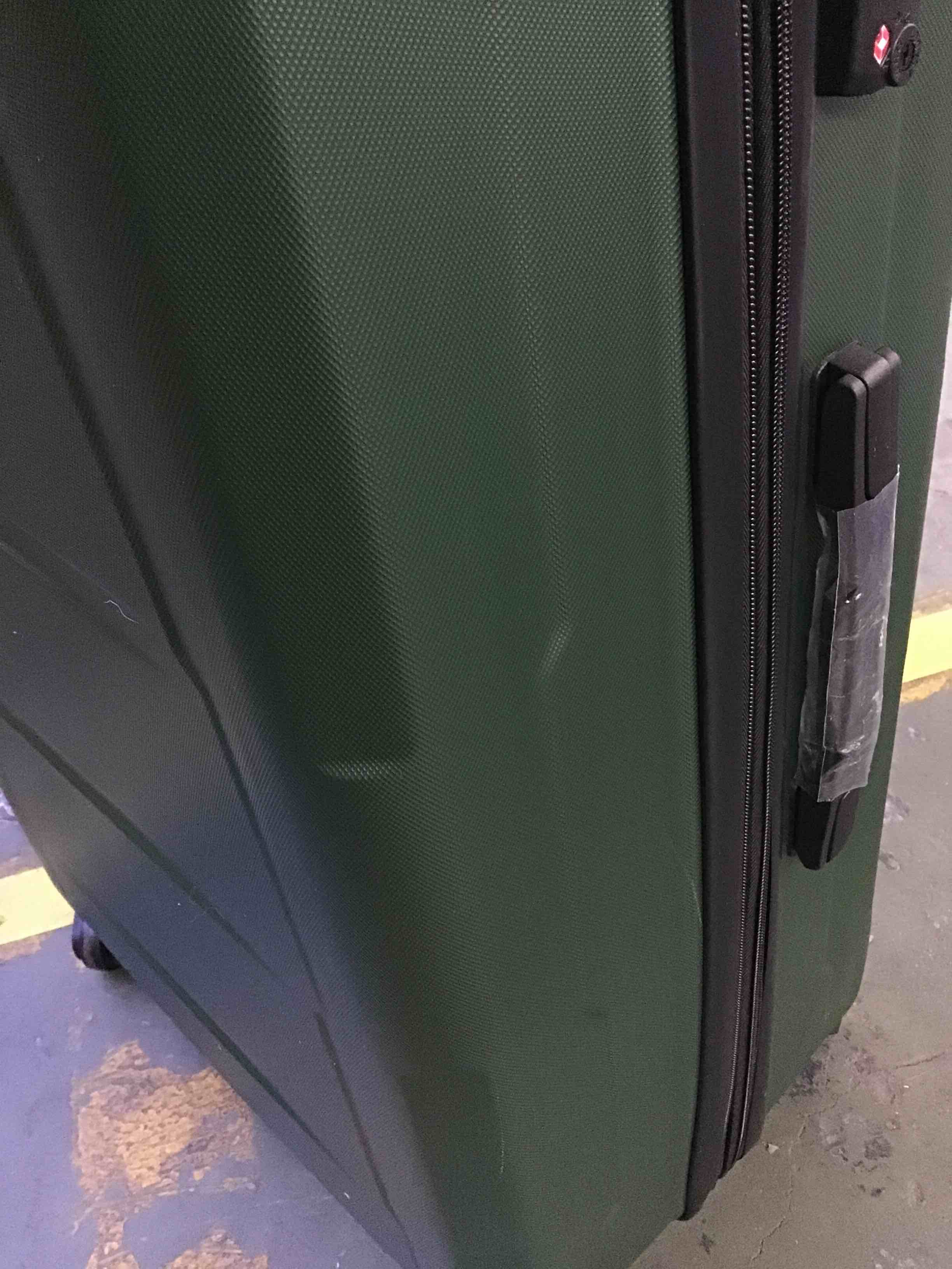 miscellaneous green suitcase has a little scratches on it