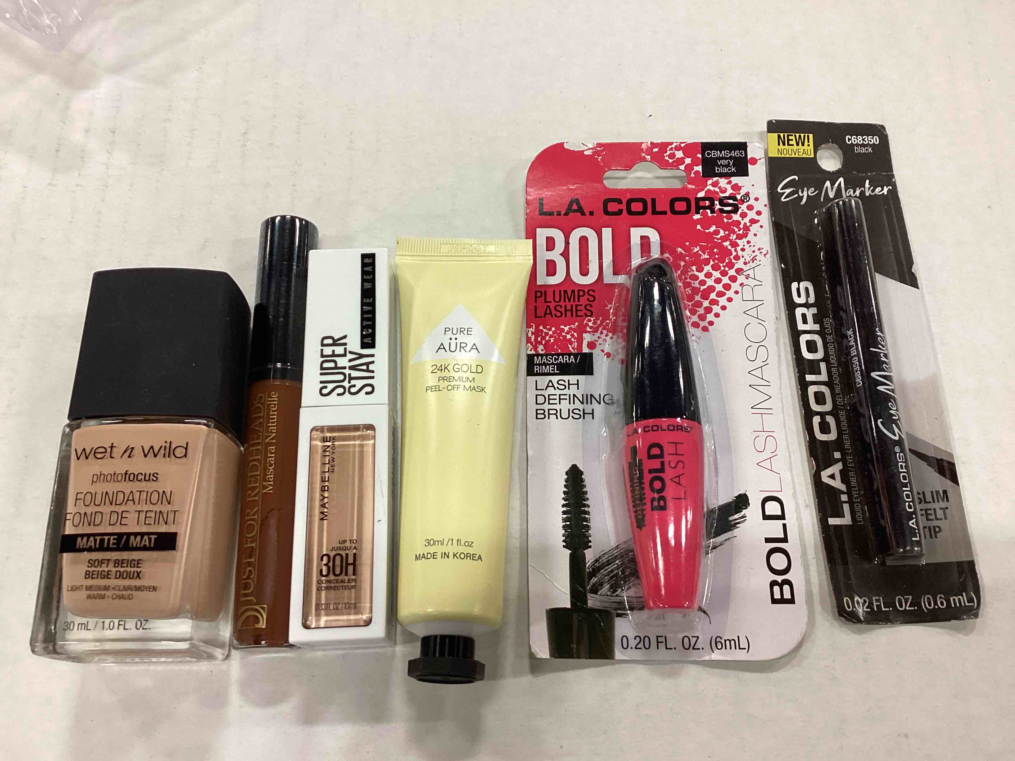 WET N WILD FOUNDATION, JUST FOR REDHEADS MASCARA, MAYBELLINE CONCEALER, PUR AURA FACE MASK, LA COLORS BOLD LASH, LA COLORS EYE MARKER