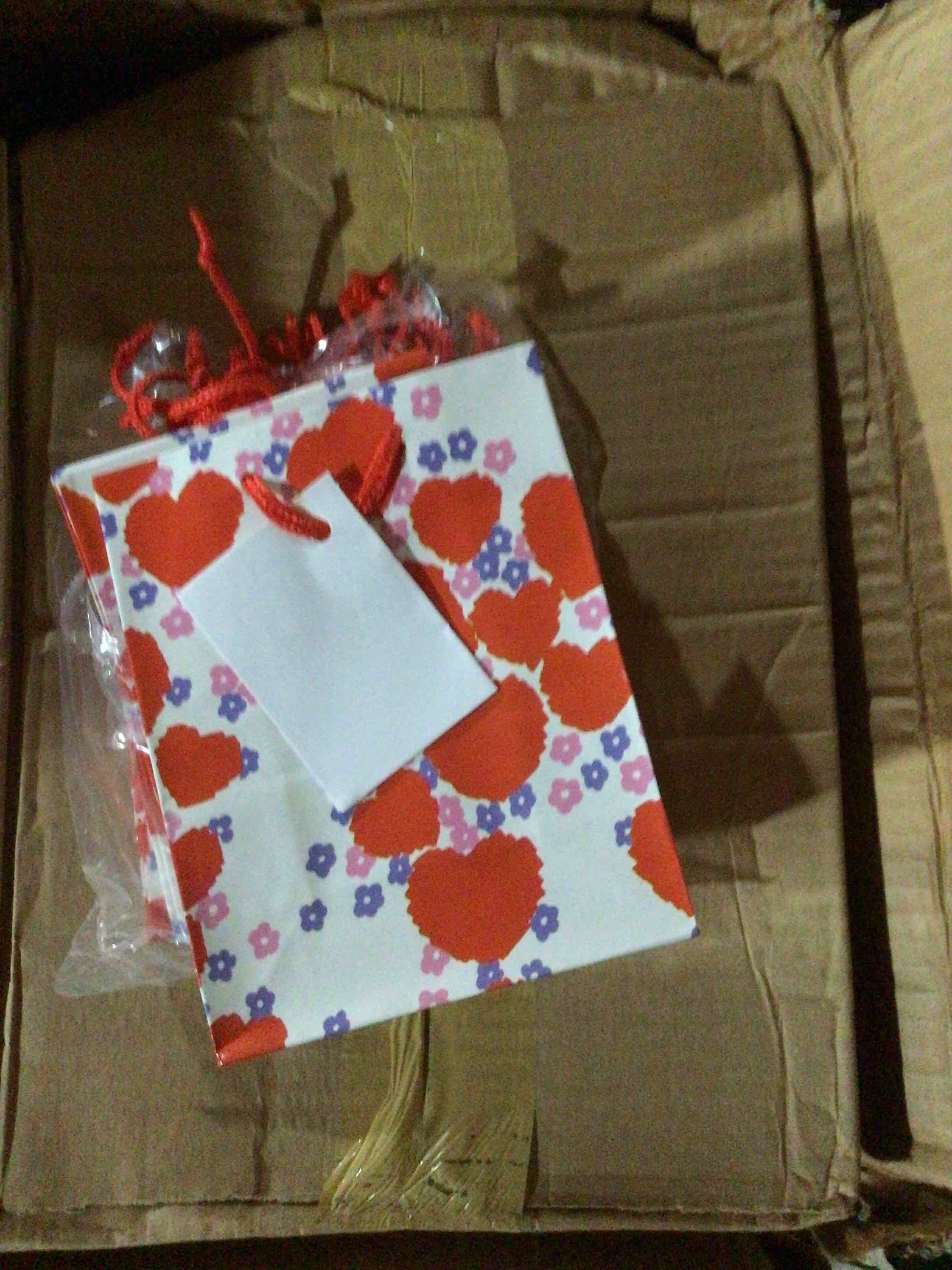 Gift with a festive print.it is designed with red hearts