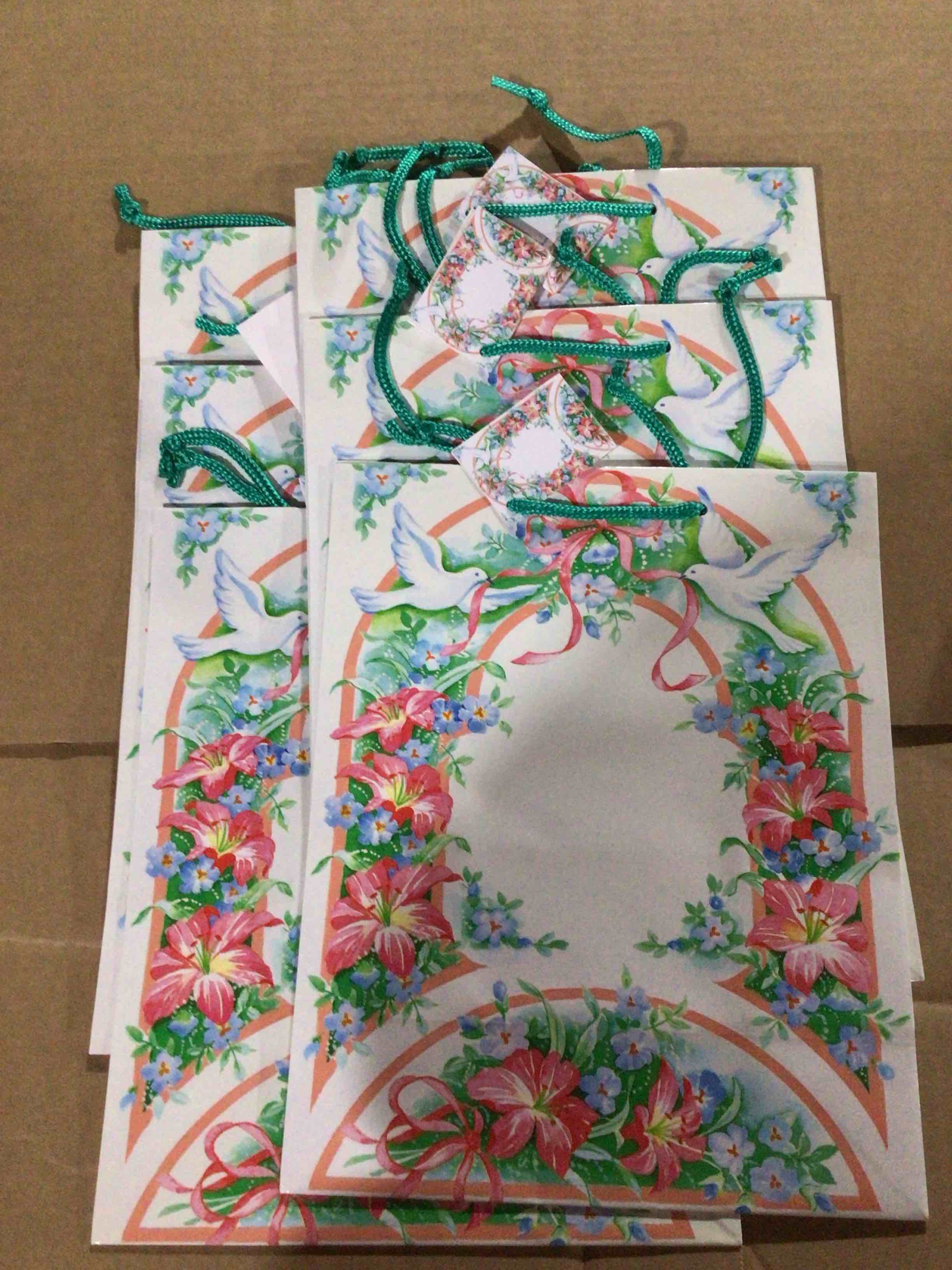 Gift bags with a print of an arch of roses with two doves