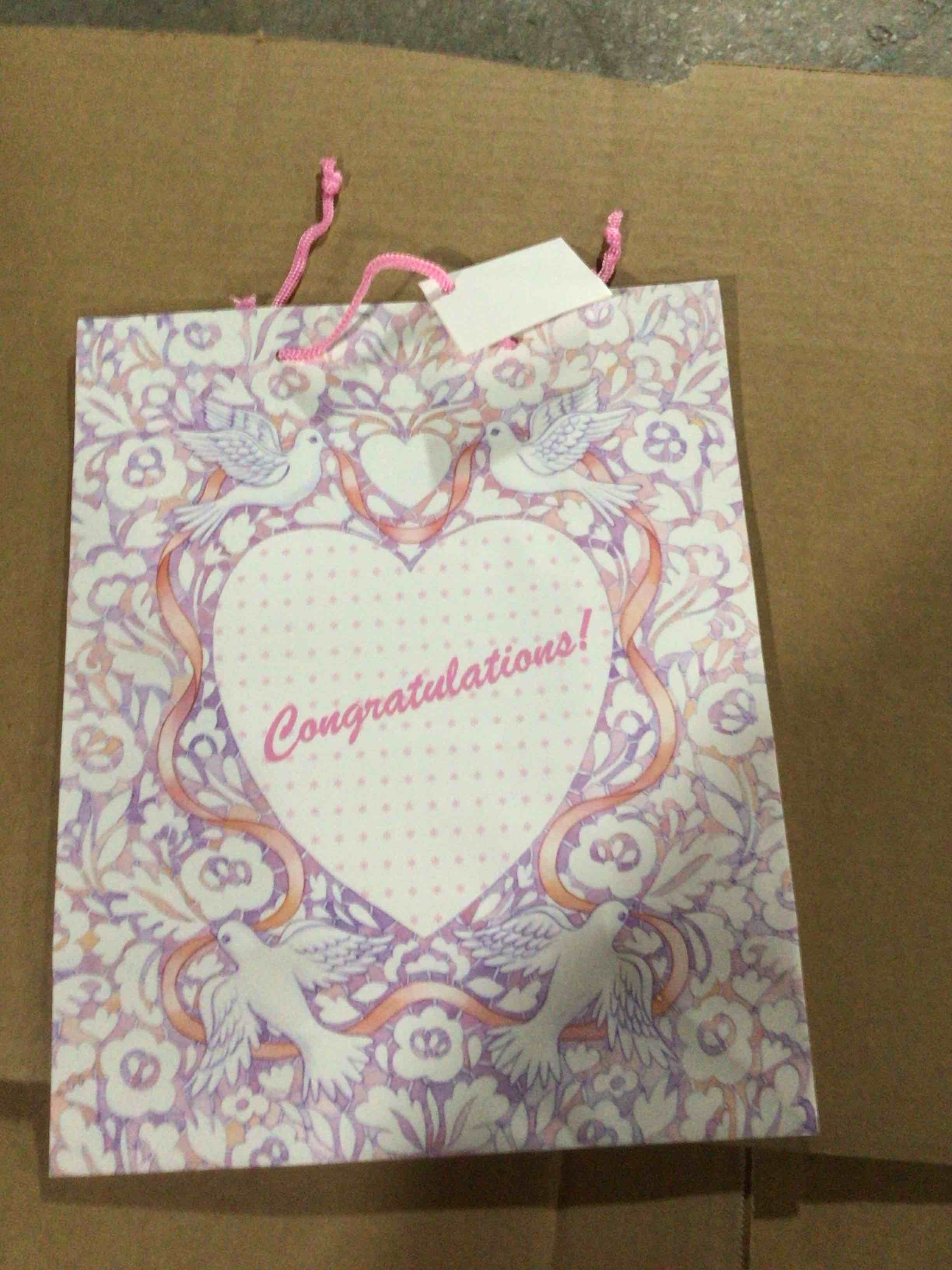 Gift bag with an ornate design , featuring two pigeons holding a heart