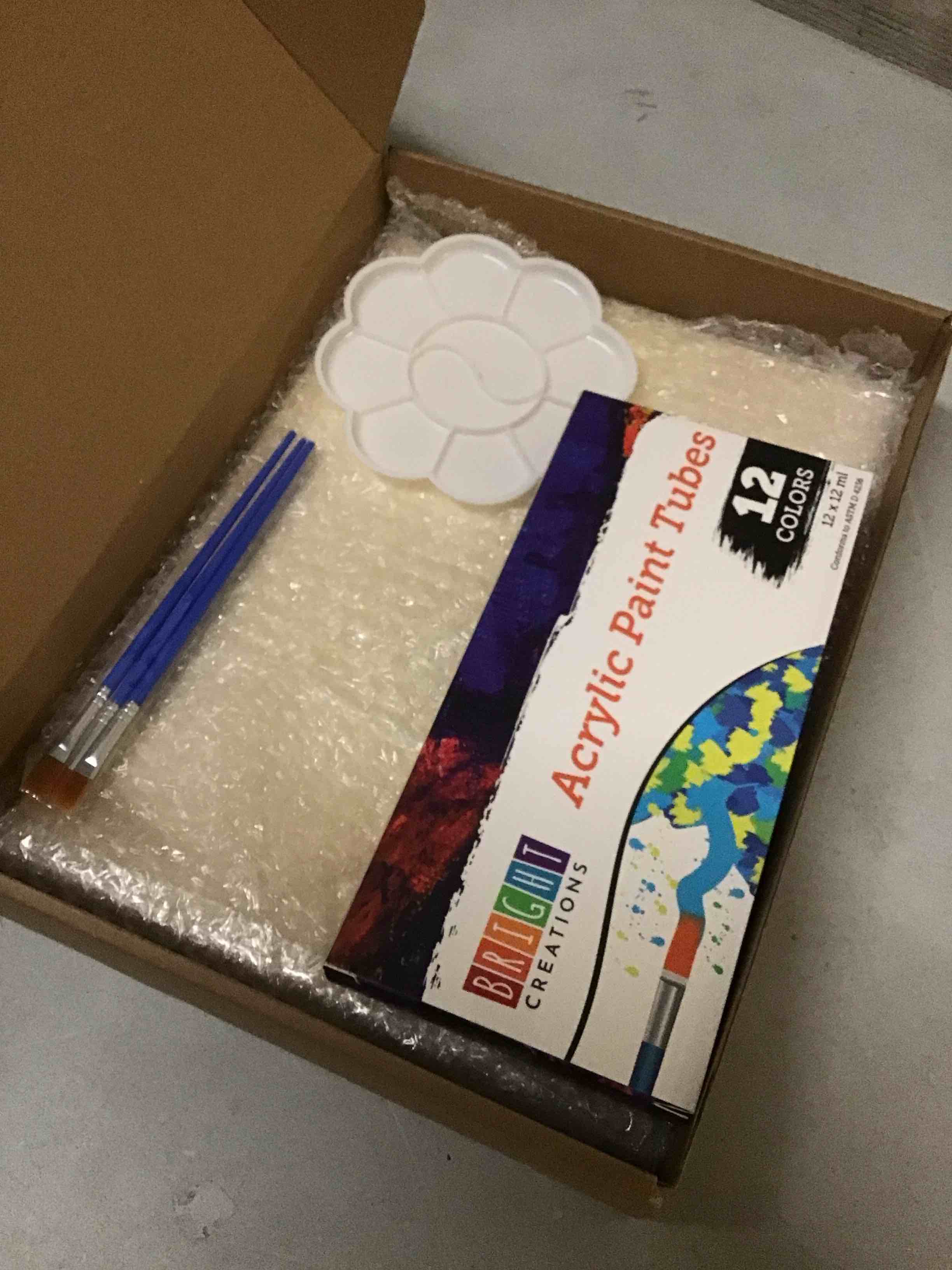 Condition photo showing New/Like New for 18-piece 9x12 -inch wooden canvas painting set, 2 natural wood panel paint boards with 12 acrylic paint tubes, 3 brushes, and 1 plastic palette for crafting and art supplies