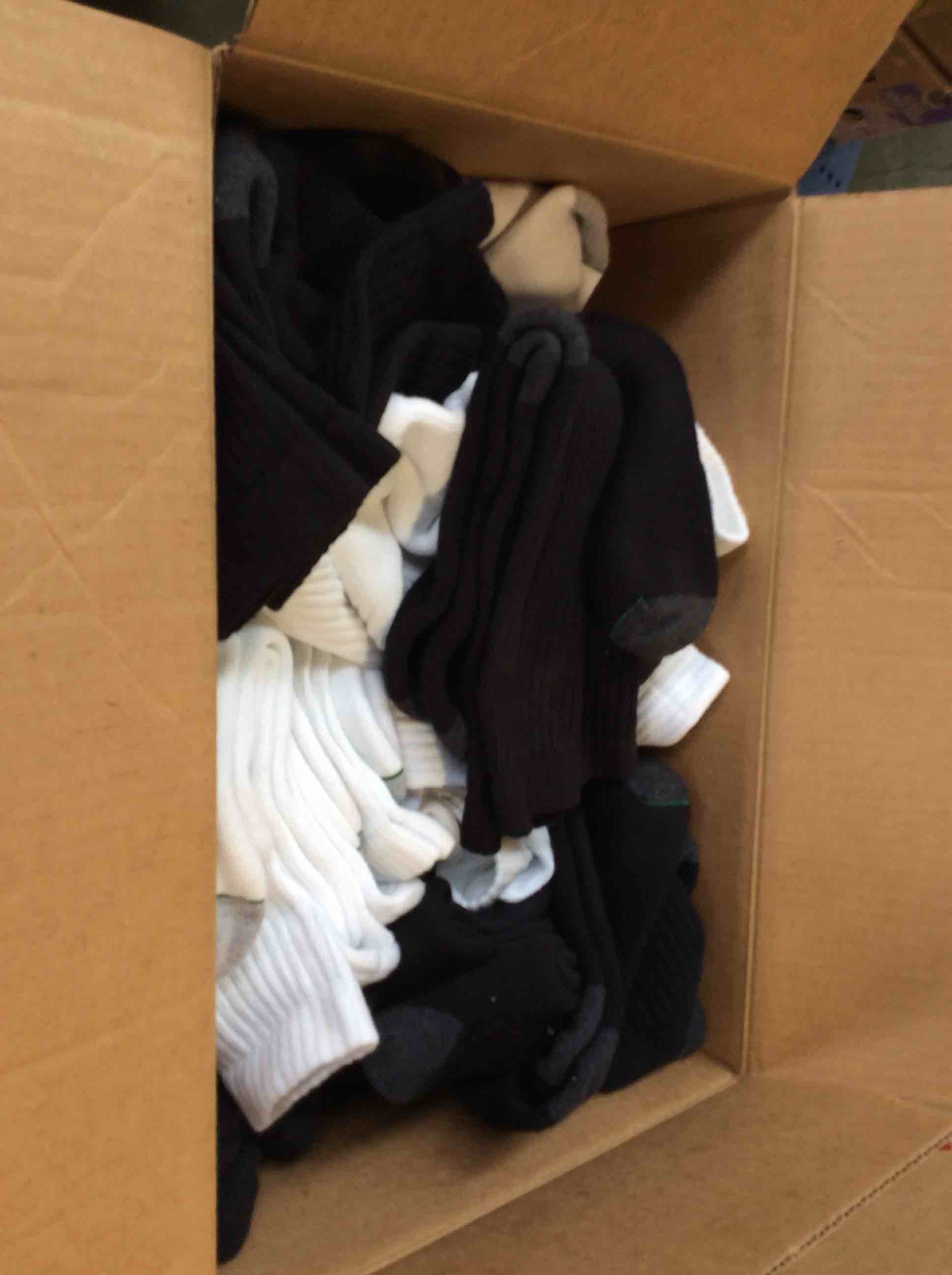 Bos filled with a variety of white and black socks 