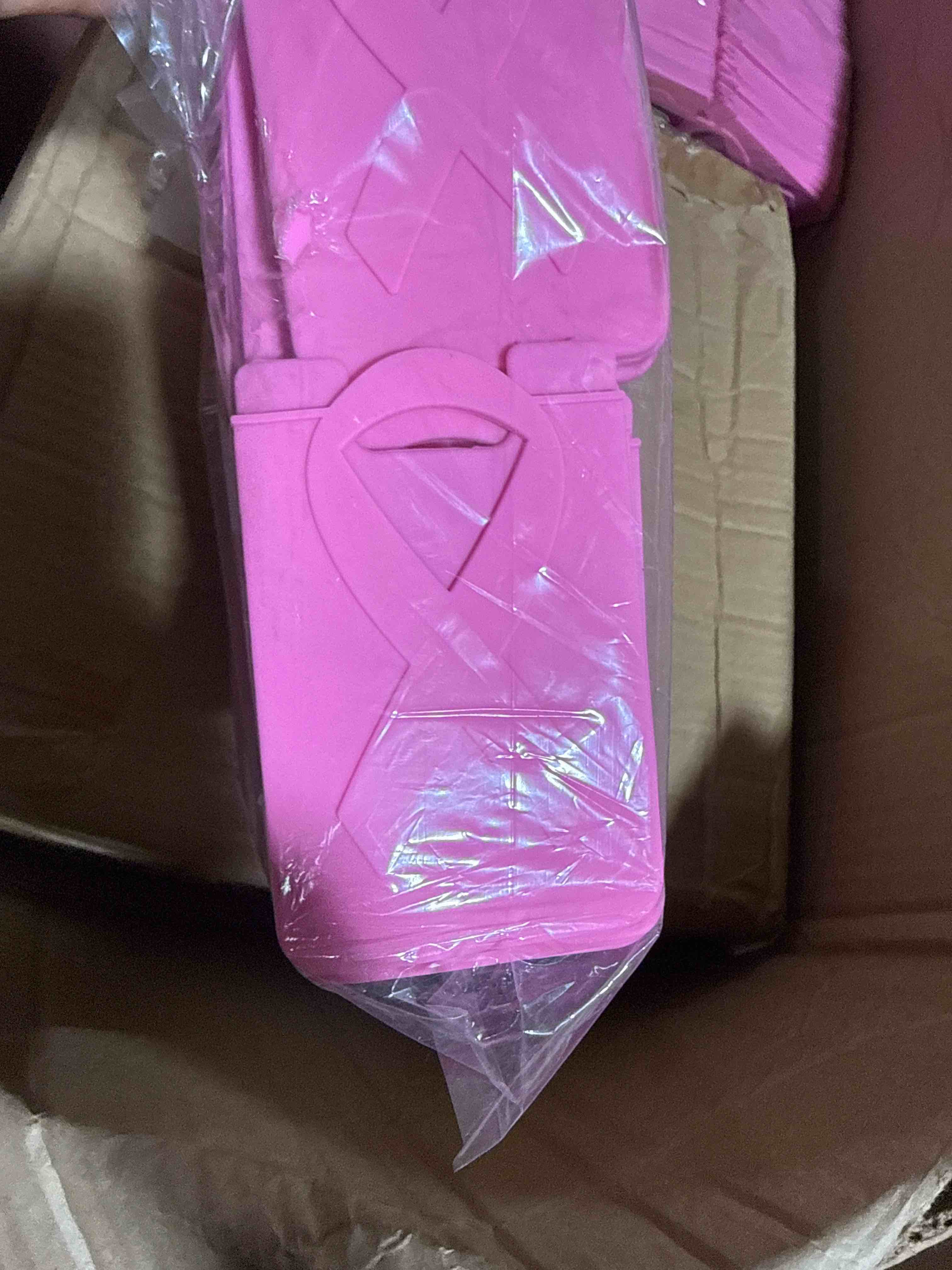 (case of 100) silicone phone wallet featuring an embossed awareness ribbon that securely sticks to the back of your phone to conveniently hold one credit card or id.