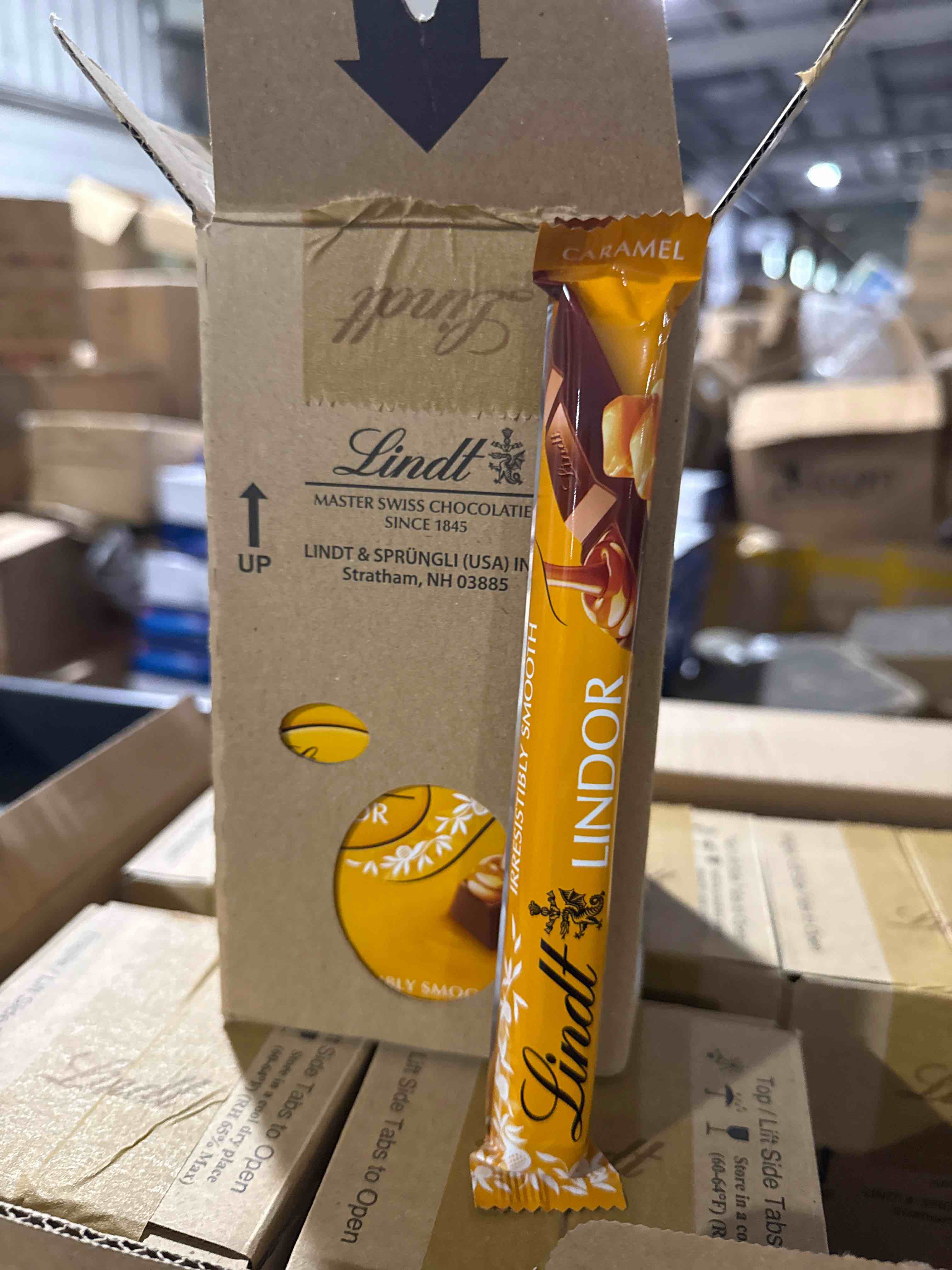 Condition photo showing New/Like New for case of 24 lindt lindor caramel & milk chocolate snap bar 1.3 oz bb 4.30.25