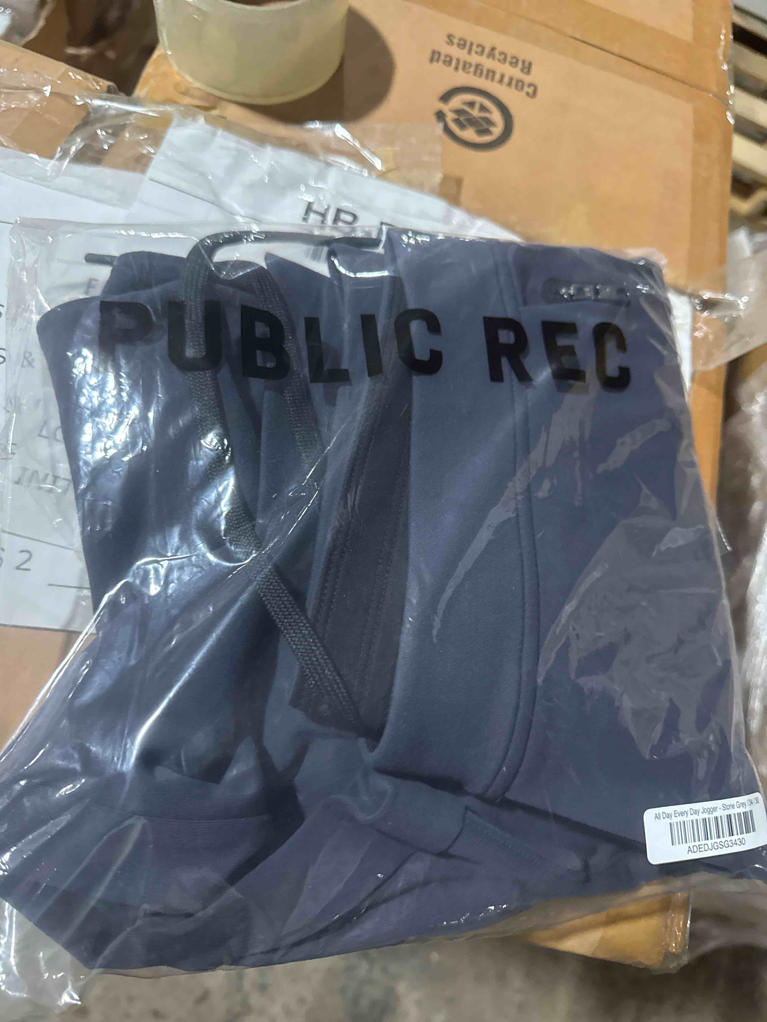 Condition photo showing New/Like New for case of 50 all day everyday jogger stone gray (assorted sizes)