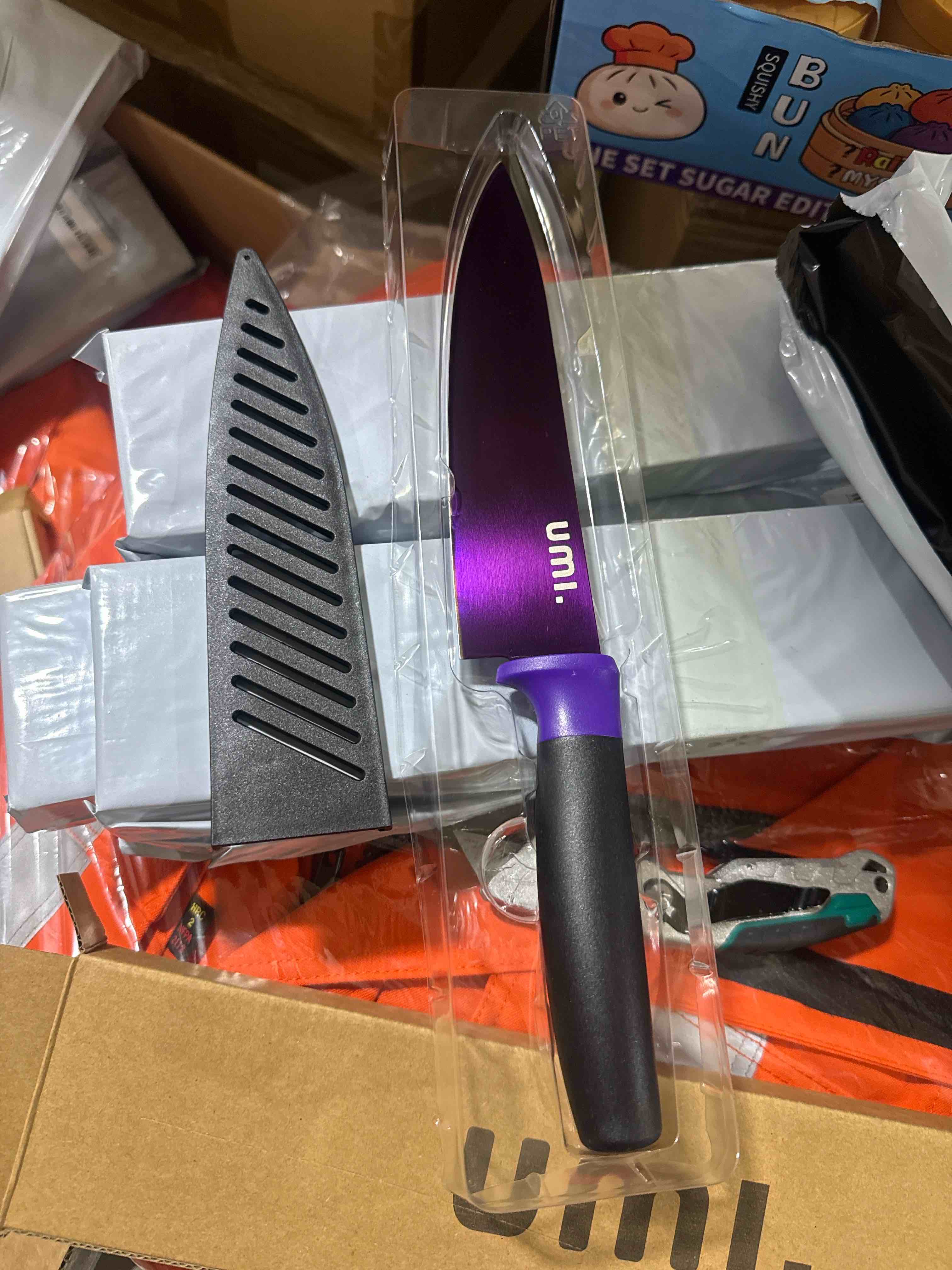 Condition photo showing Brand New for purple chef’s knife featuring a comfortable black handle and protective vented sheath for convenient, safe kitchen storage.