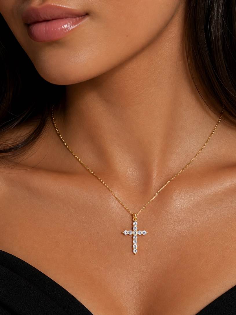Delicate gold chain necklace featuring a sparkling cross pendant,