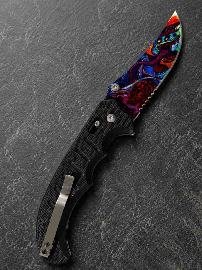 A rugged folding pocket knife featuring a textured black handle and a bold, multicolor patterned blade that delivers eye-catching style with reliable everyday performance.