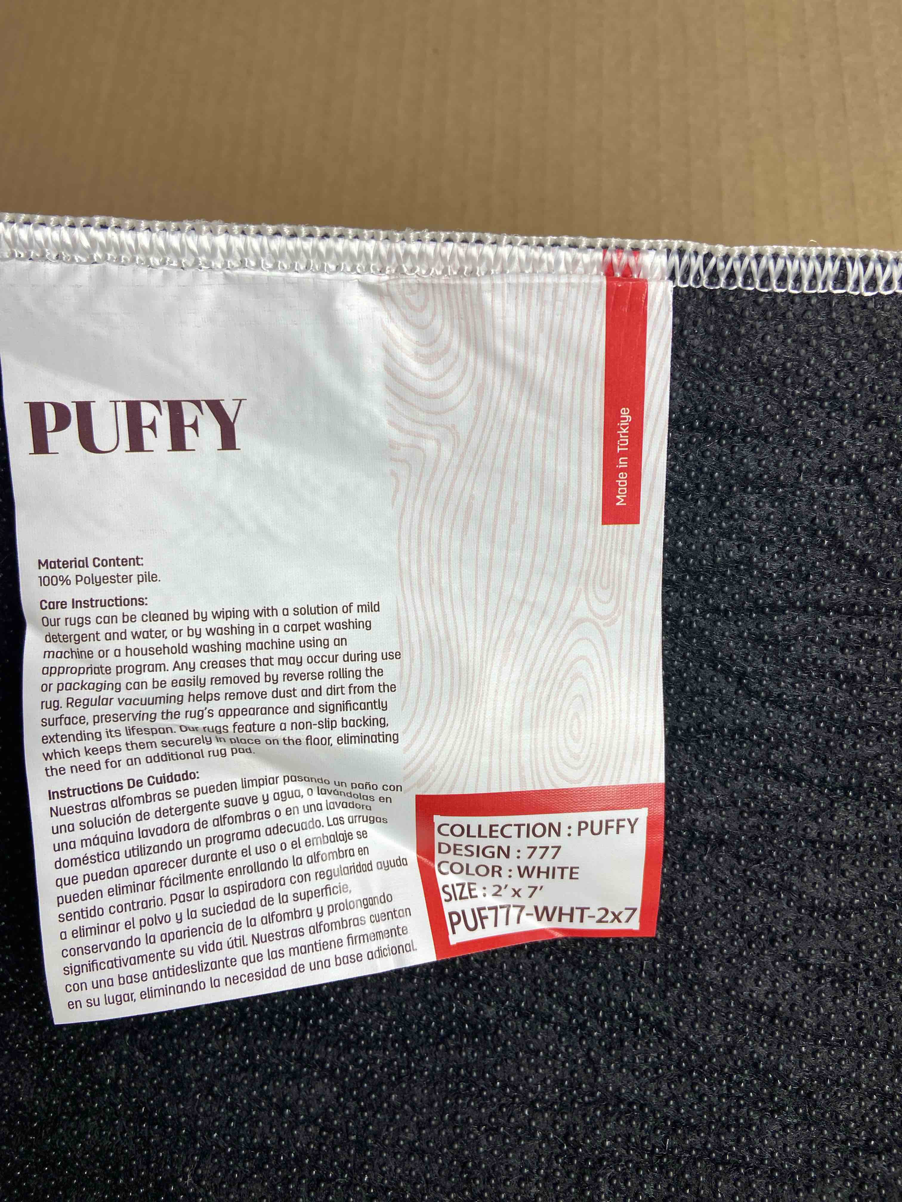 Condition photo showing New/Like New for puffy white area rug 2’x7’ 