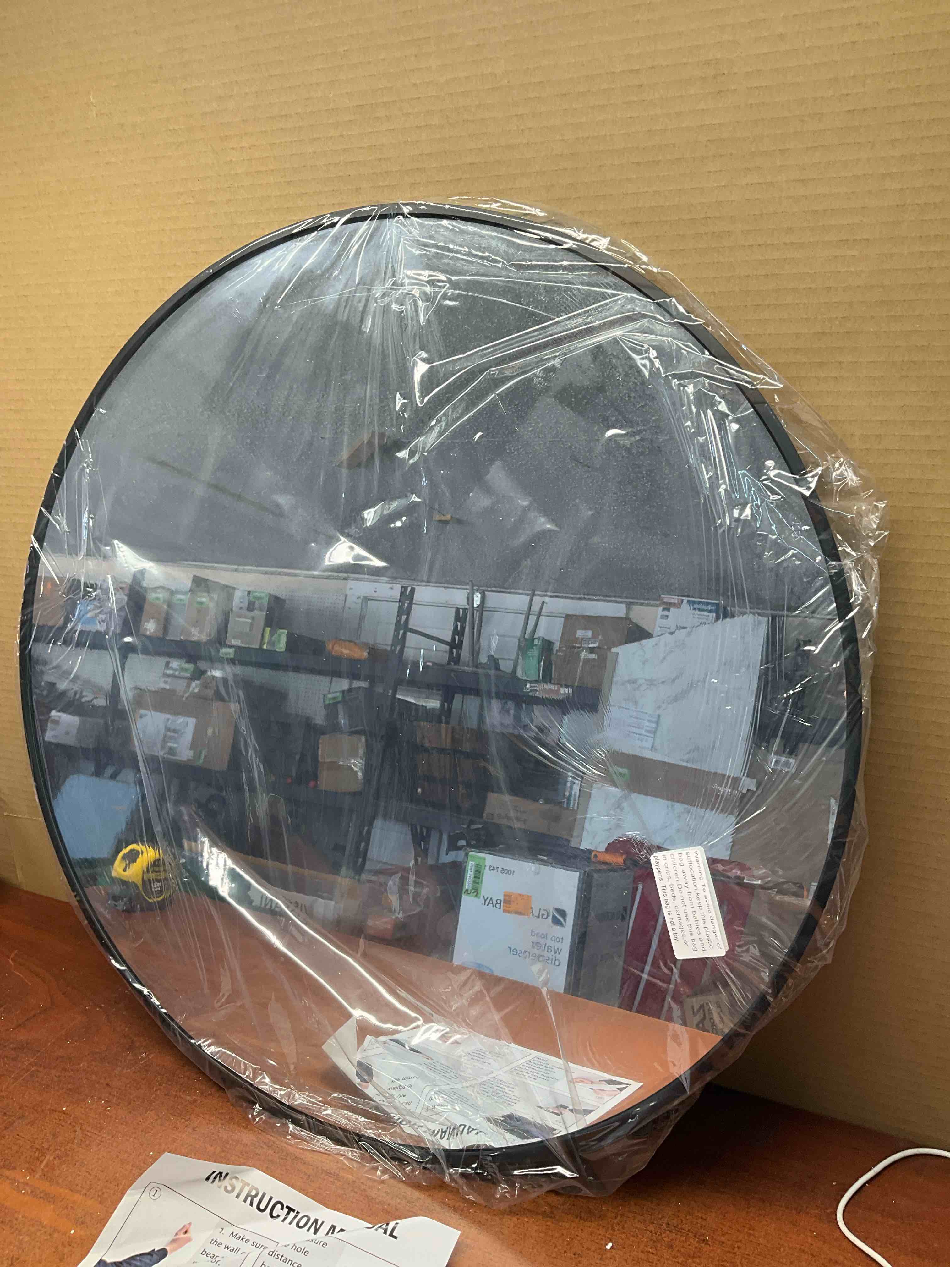 24” Round wall mirror with black frame