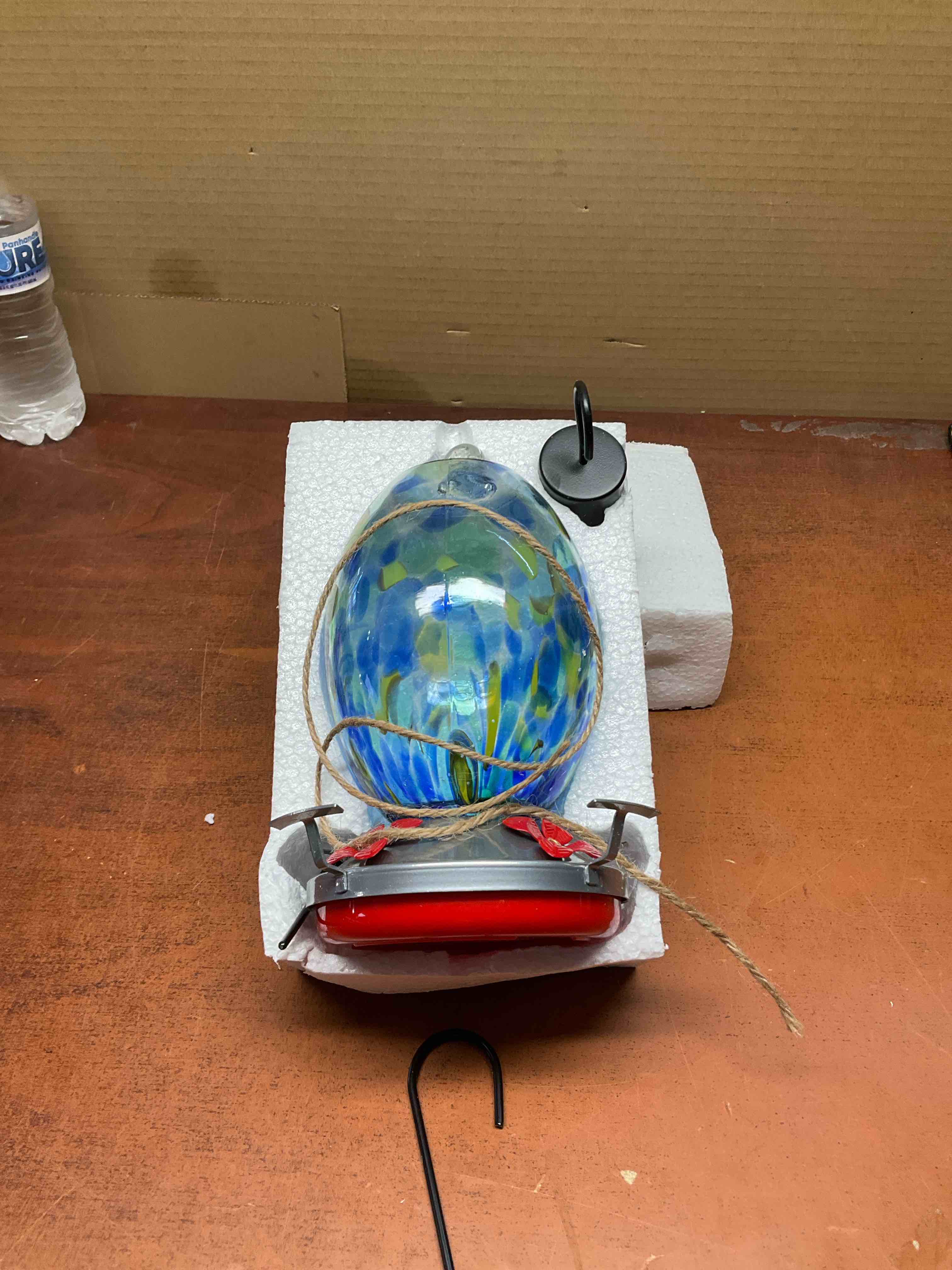 Clear glass and 2-part base for easy viewing Unique shiny colors attract hummingbirds to your backyard Includes hook, metal hanger, cotton lanyard, br