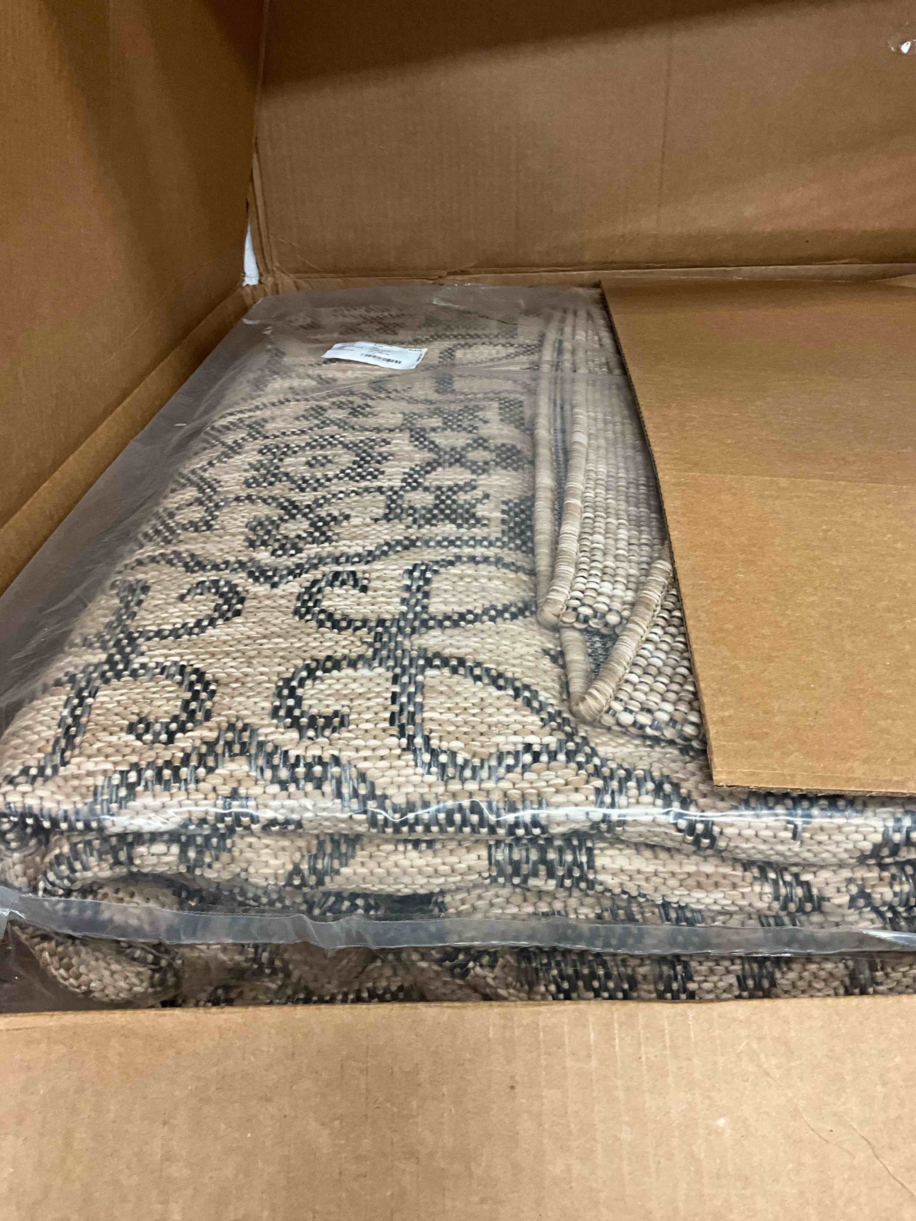 Condition photo showing New/Like New for Eliza Jute and Black 10 ft. x 13 ft. Indoor/Outdoor Area Rug