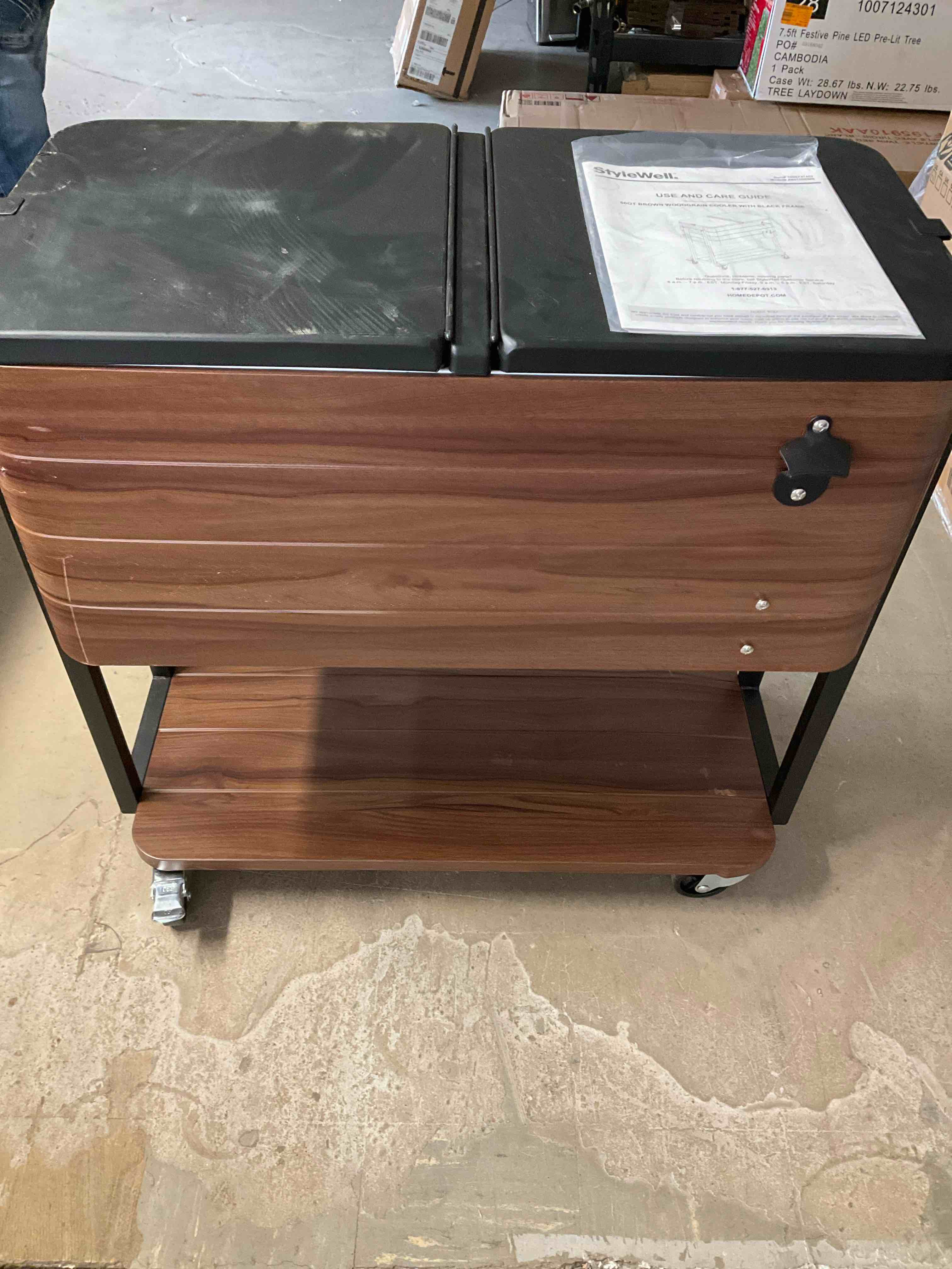 Rolling 80qt Brown wood grain cooler with black frame** frame needs to be tightened and missing bottle cap bin**