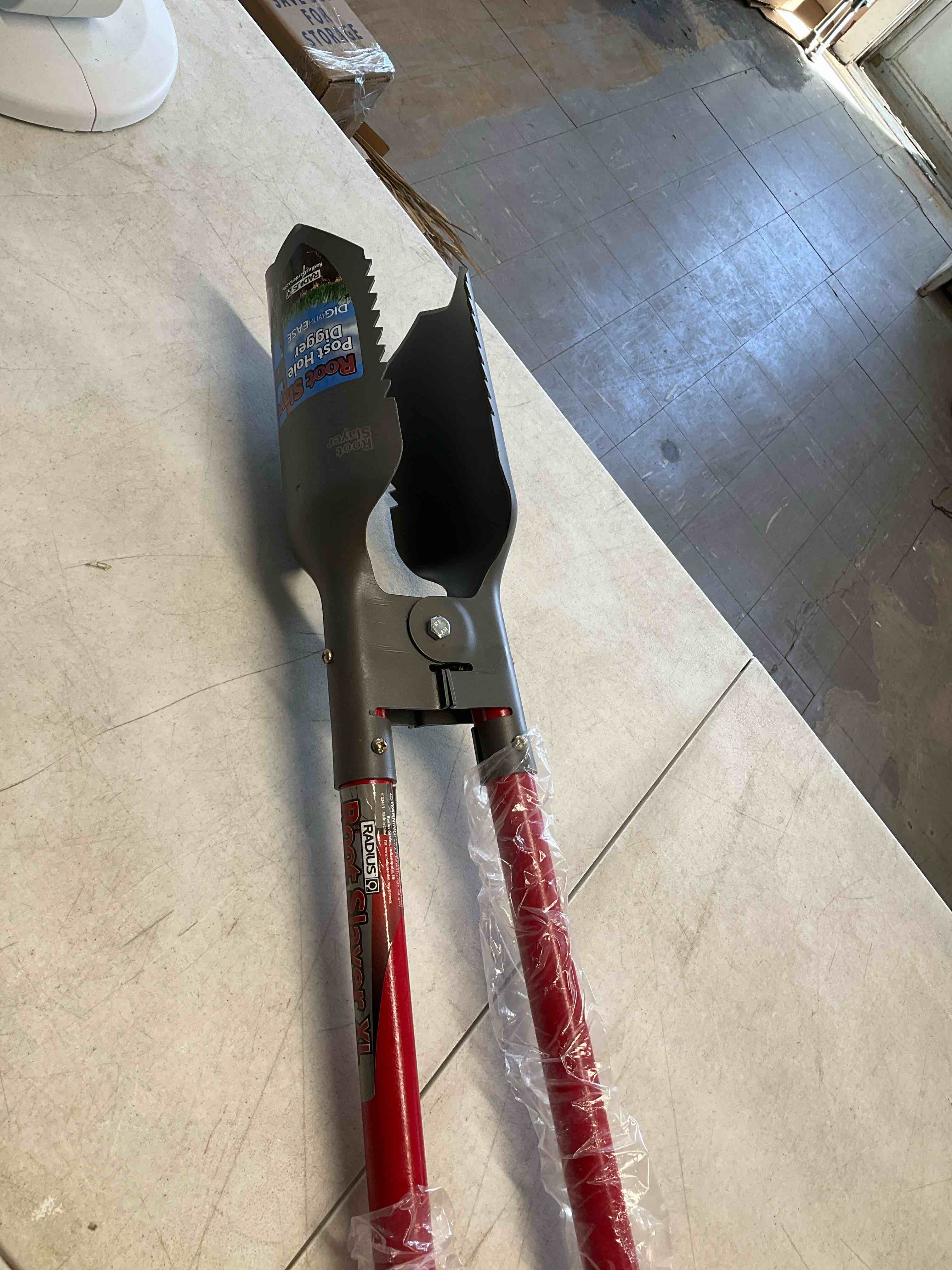 Condition photo showing New/Like New for 60 in. root slayer carbon steel blades fiberglass post hole digger, 47 in. handle by radius garden (brand rating: 4.6/5) heat-treated carbon steel blades for durability fiberglass handles reduce flexing and improve dig quality dual root digger cuts through roots